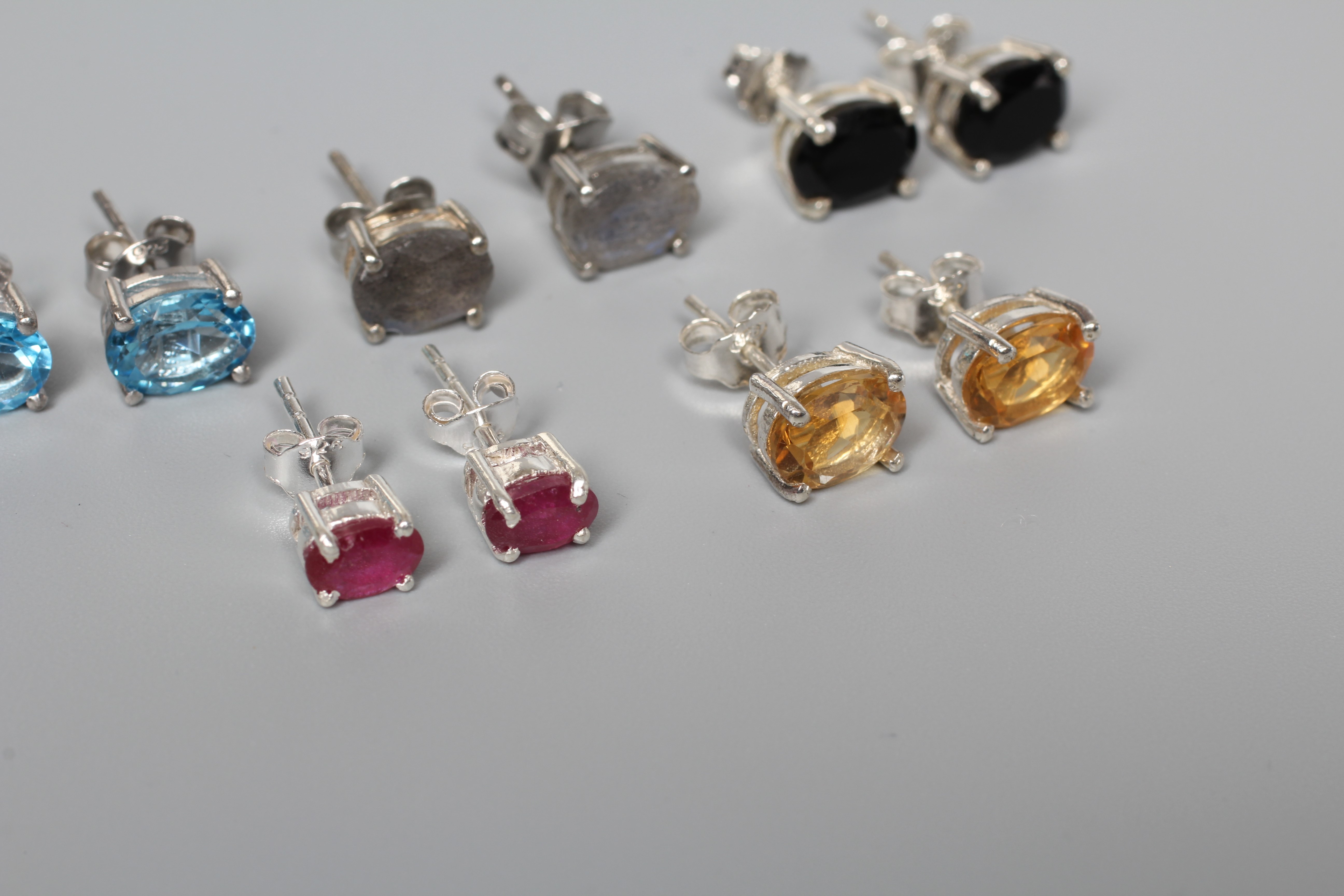FIVE PAIRS OF SILVER EAR STUDS including citrines, onyx and blue topaz Image