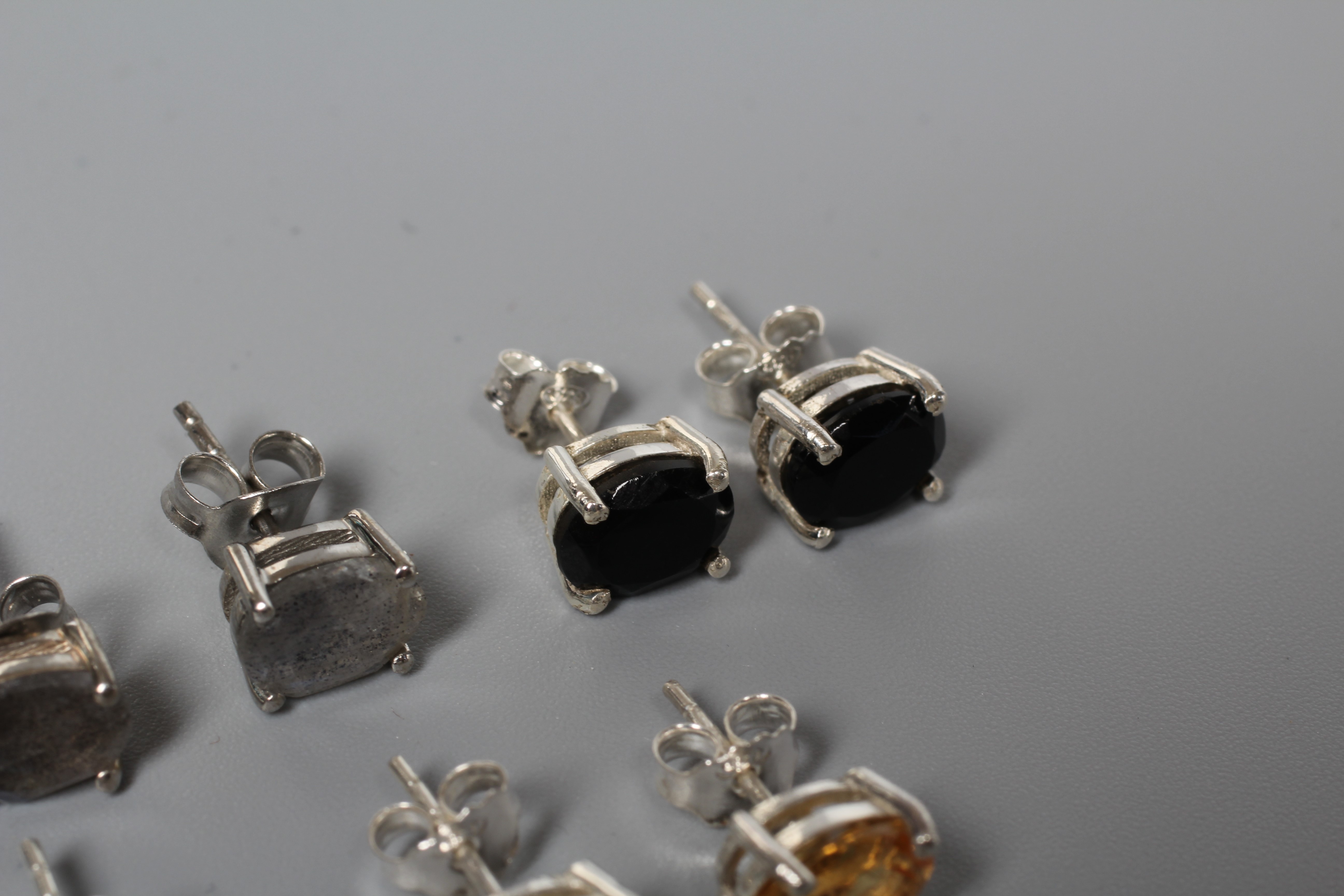 FIVE PAIRS OF SILVER EAR STUDS including citrines, onyx and blue topaz Image