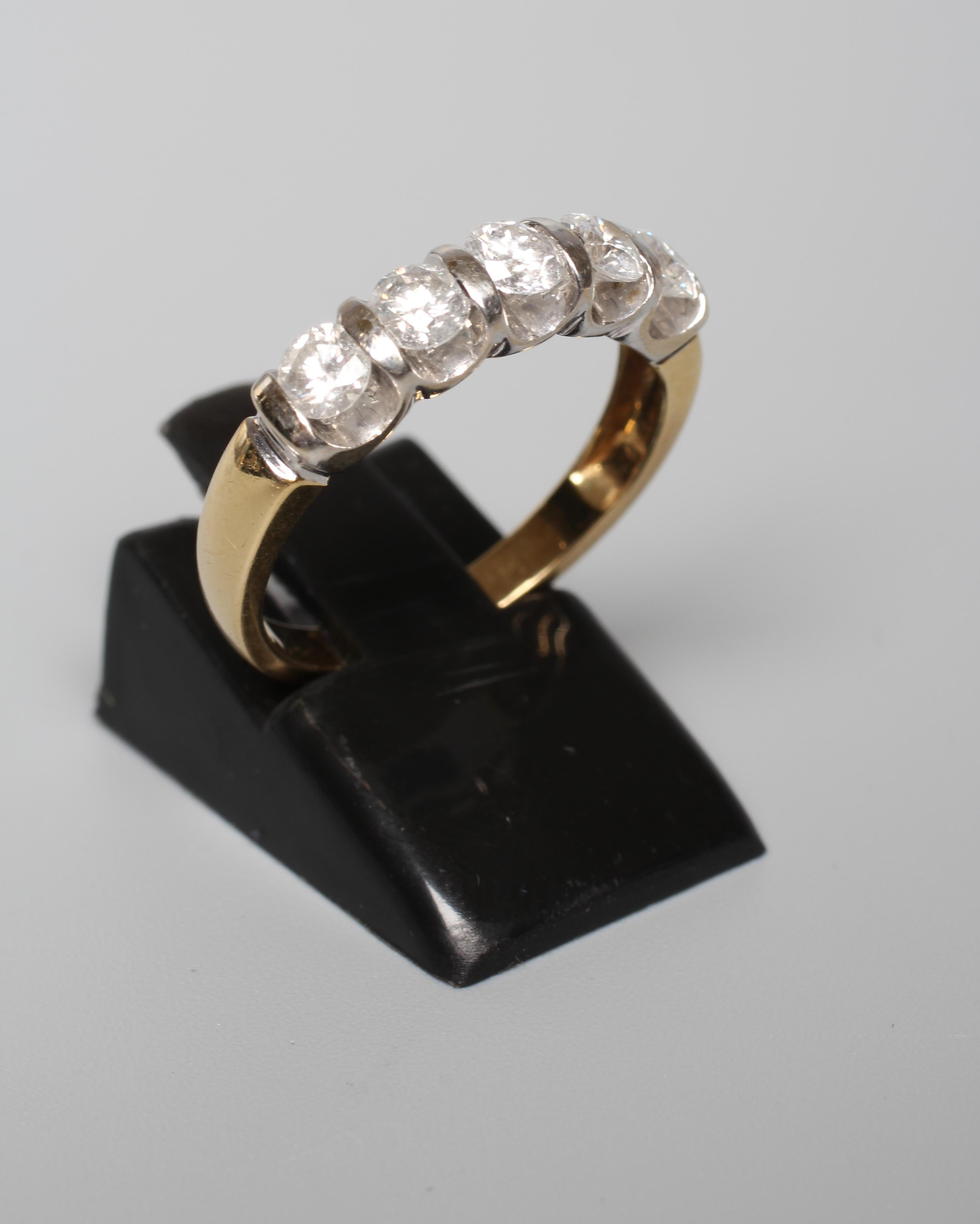 A FIVE STONE DIAMOND RING, the round brilliants totalling 1ct, bar set to an 18ct gold shank, size O Image