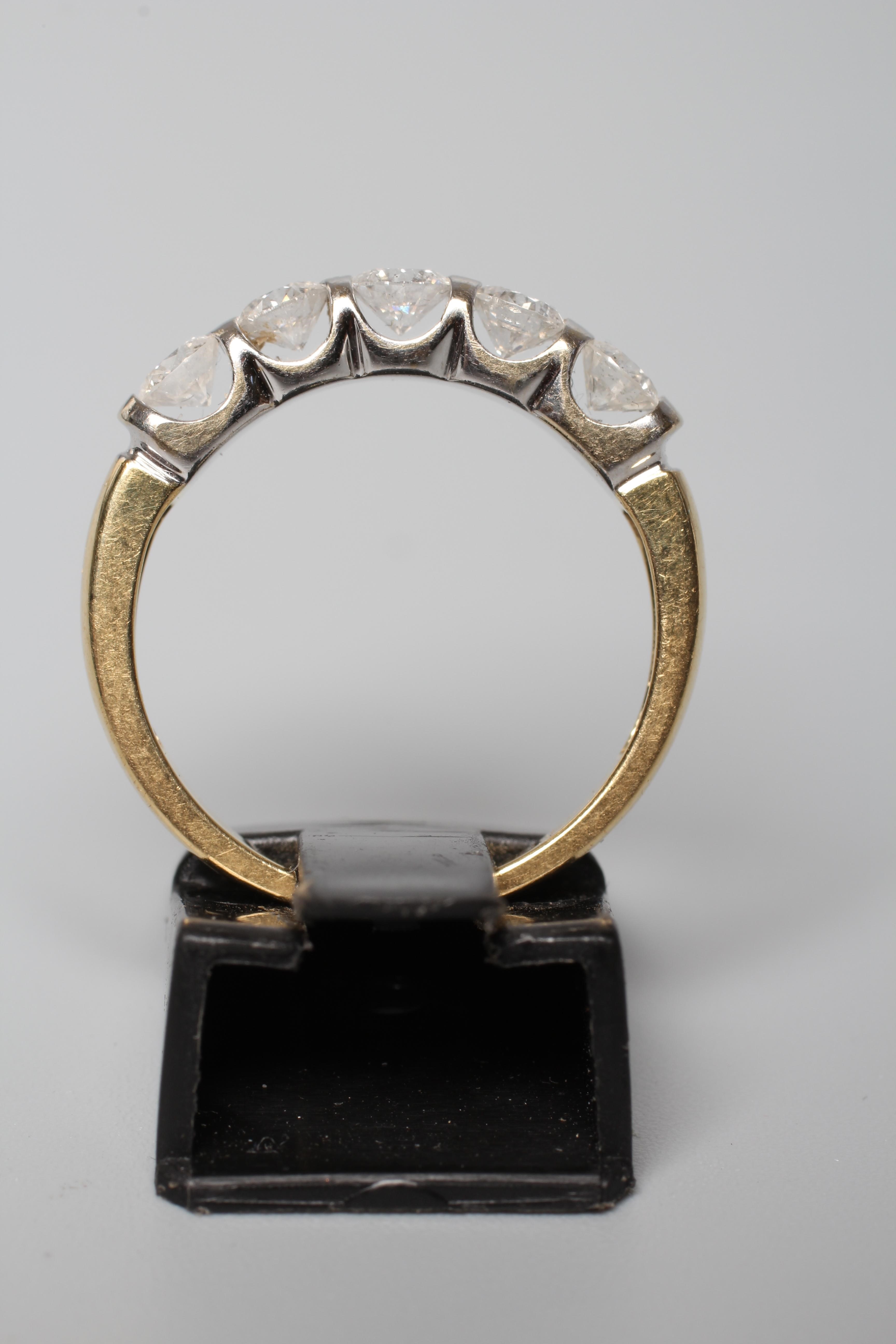 A FIVE STONE DIAMOND RING, the round brilliants totalling 1ct, bar set to an 18ct gold shank, size O Image