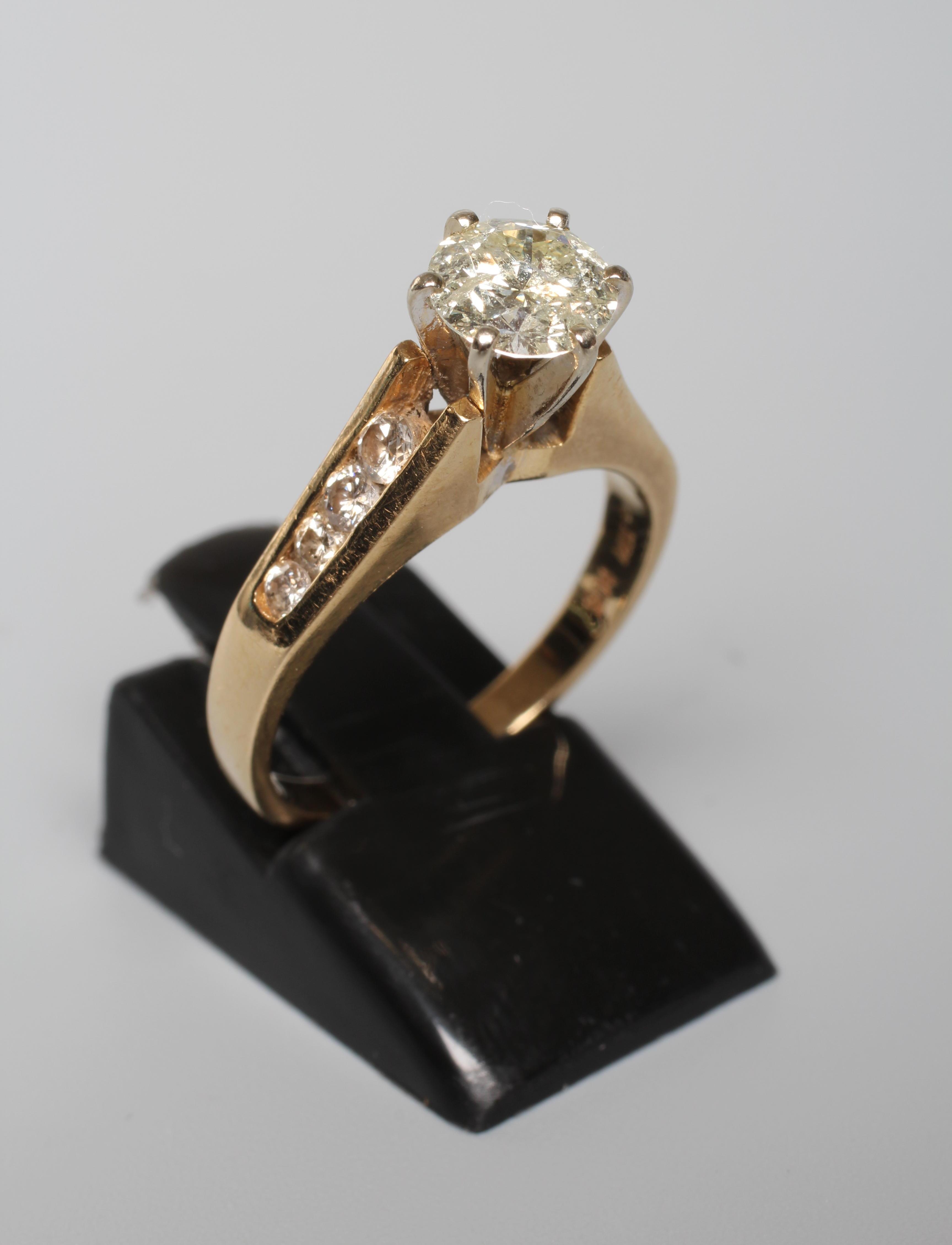 A DIAMOND SOLITAIRE RING, the round brilliant cut stone of 1.09cts, claw set in a 'Cathedral' mount Image