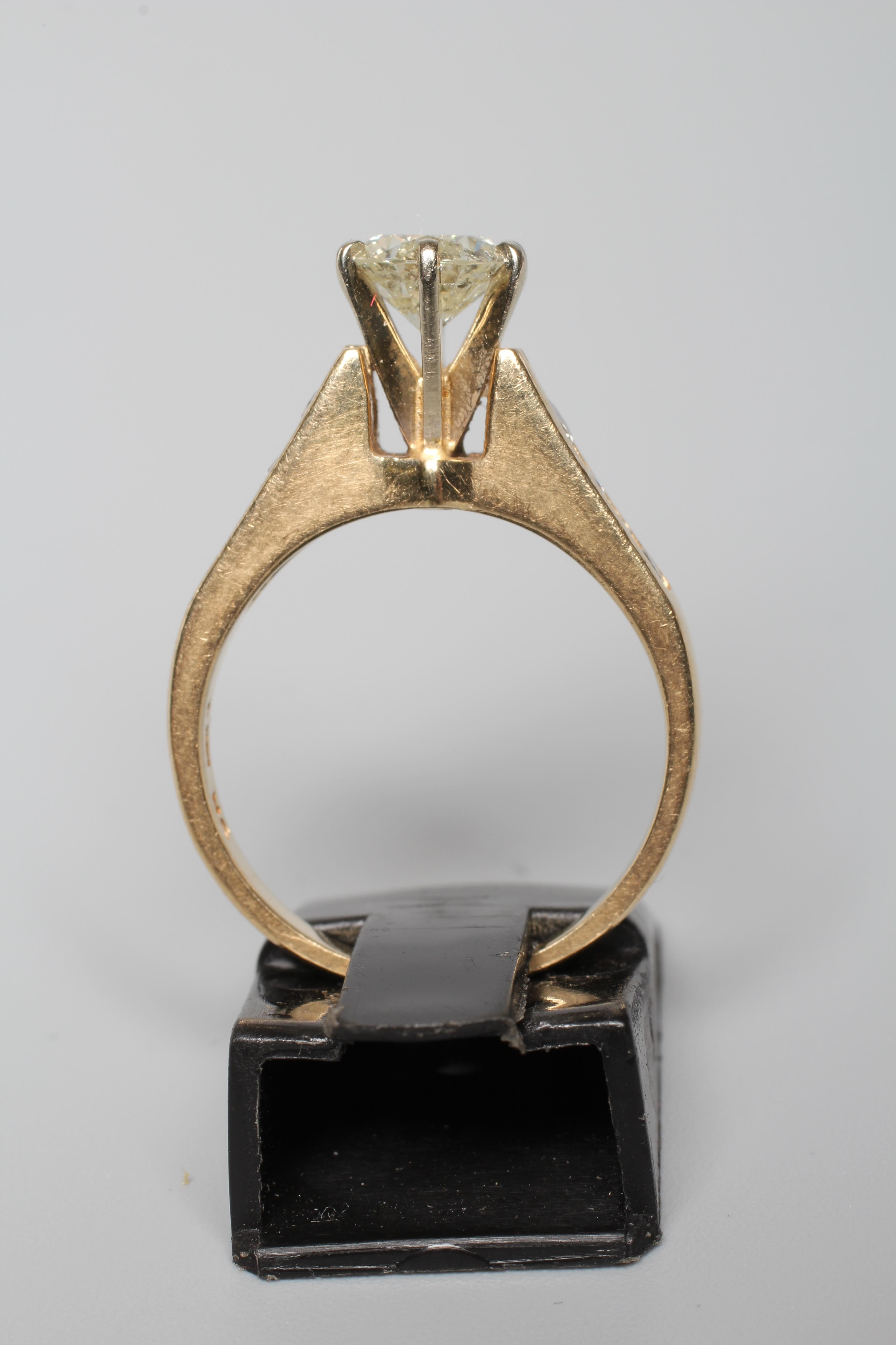 A DIAMOND SOLITAIRE RING, the round brilliant cut stone of 1.09cts, claw set in a 'Cathedral' mount Image