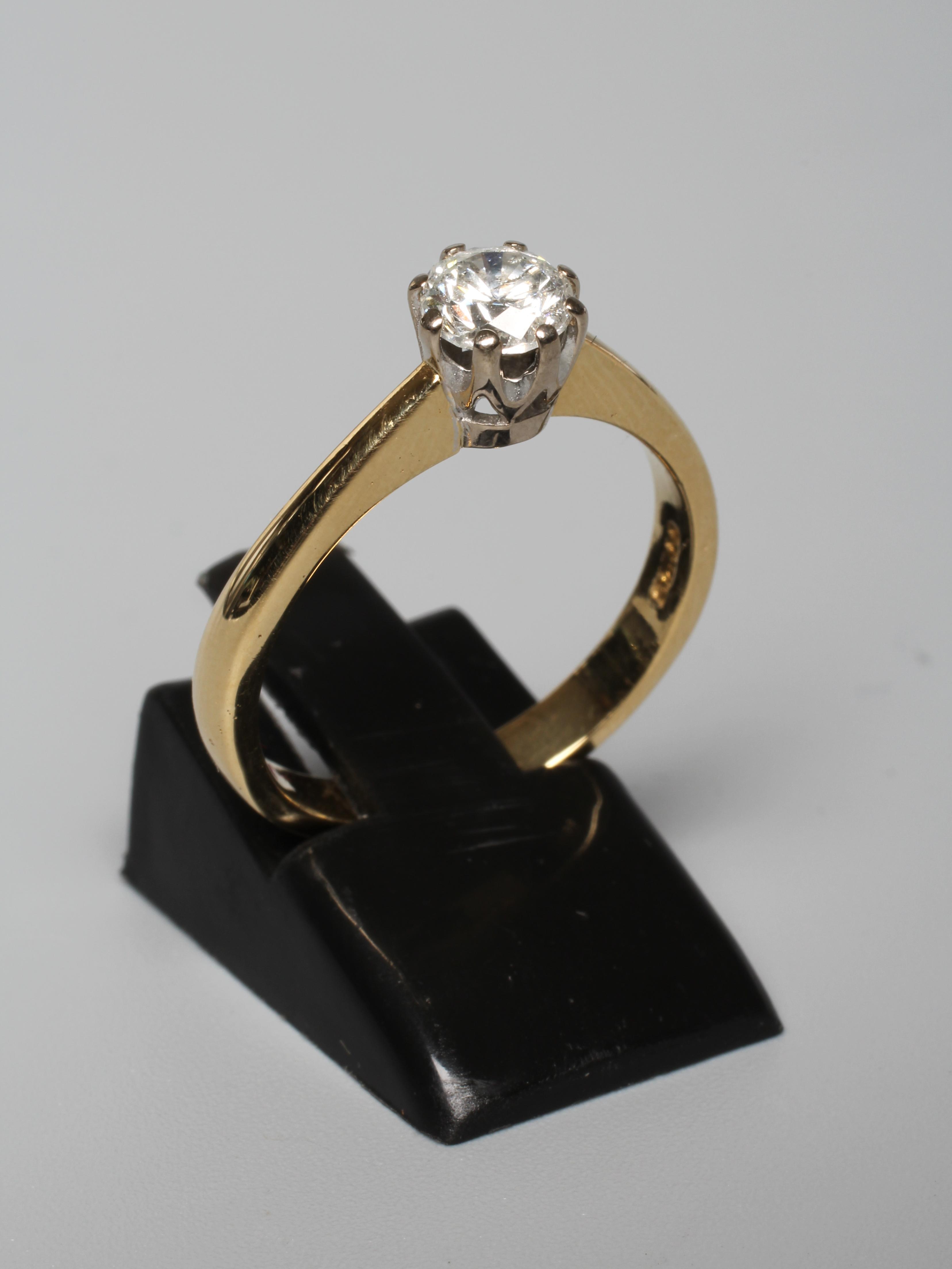 A SOLITAIRE DIAMOND RING, the round brilliant cut stone of approximately 0.65cts, claw set to a Image