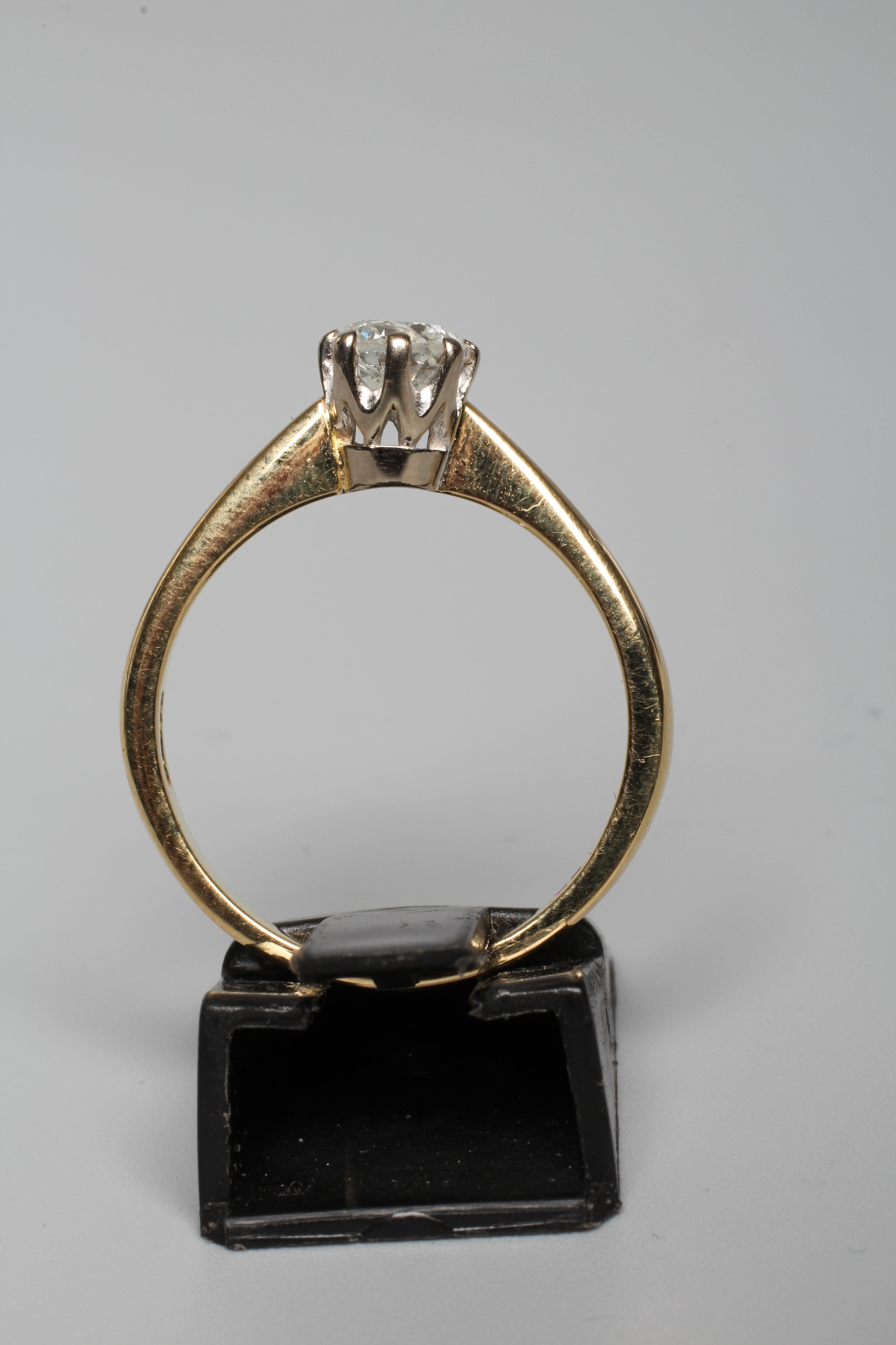 A SOLITAIRE DIAMOND RING, the round brilliant cut stone of approximately 0.65cts, claw set to a Image