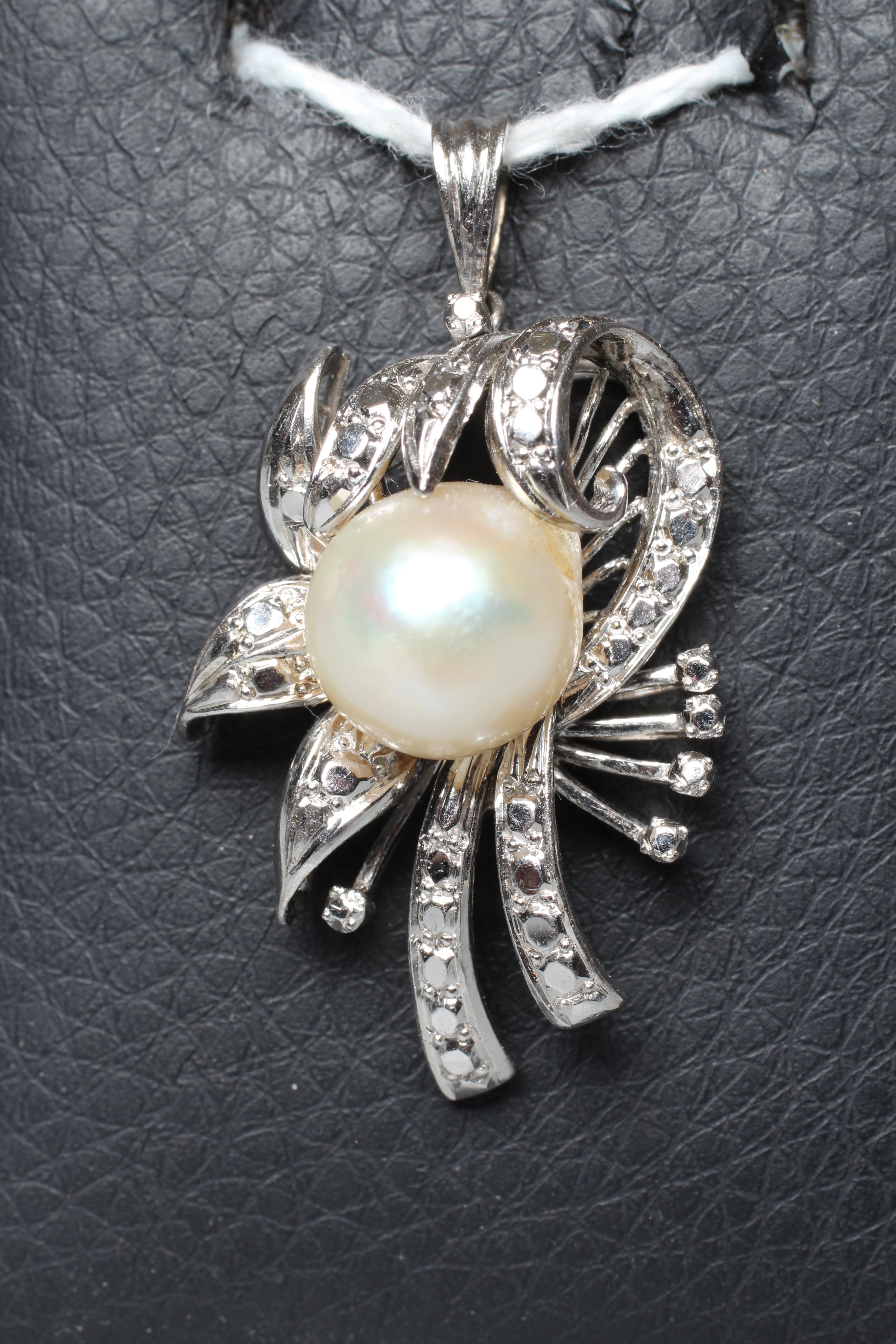 AN ABSTRACT FLOWER SPRAY PENDANT, the central cultured pearl peg set to a white frame to imitate Image
