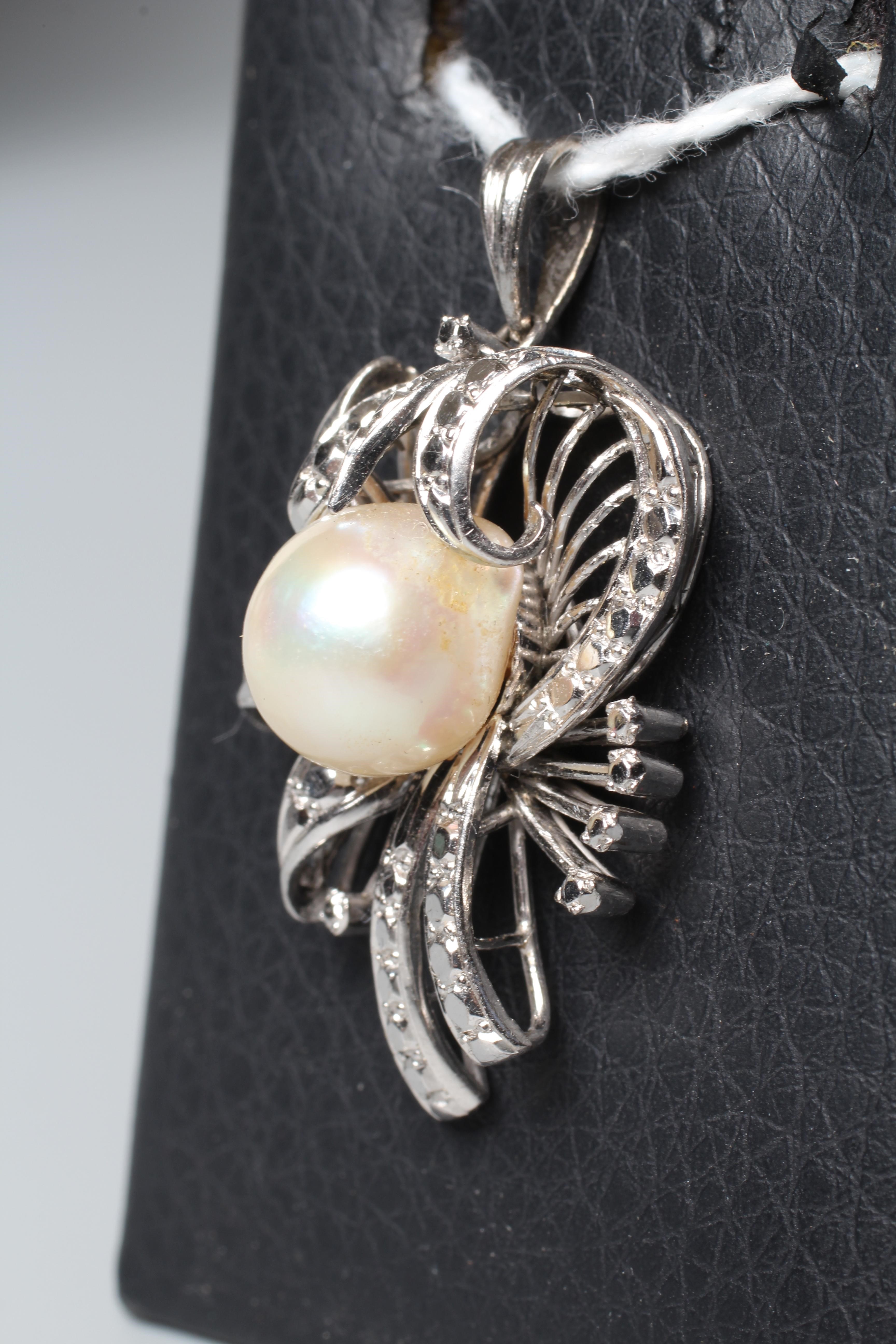 AN ABSTRACT FLOWER SPRAY PENDANT, the central cultured pearl peg set to a white frame to imitate Image