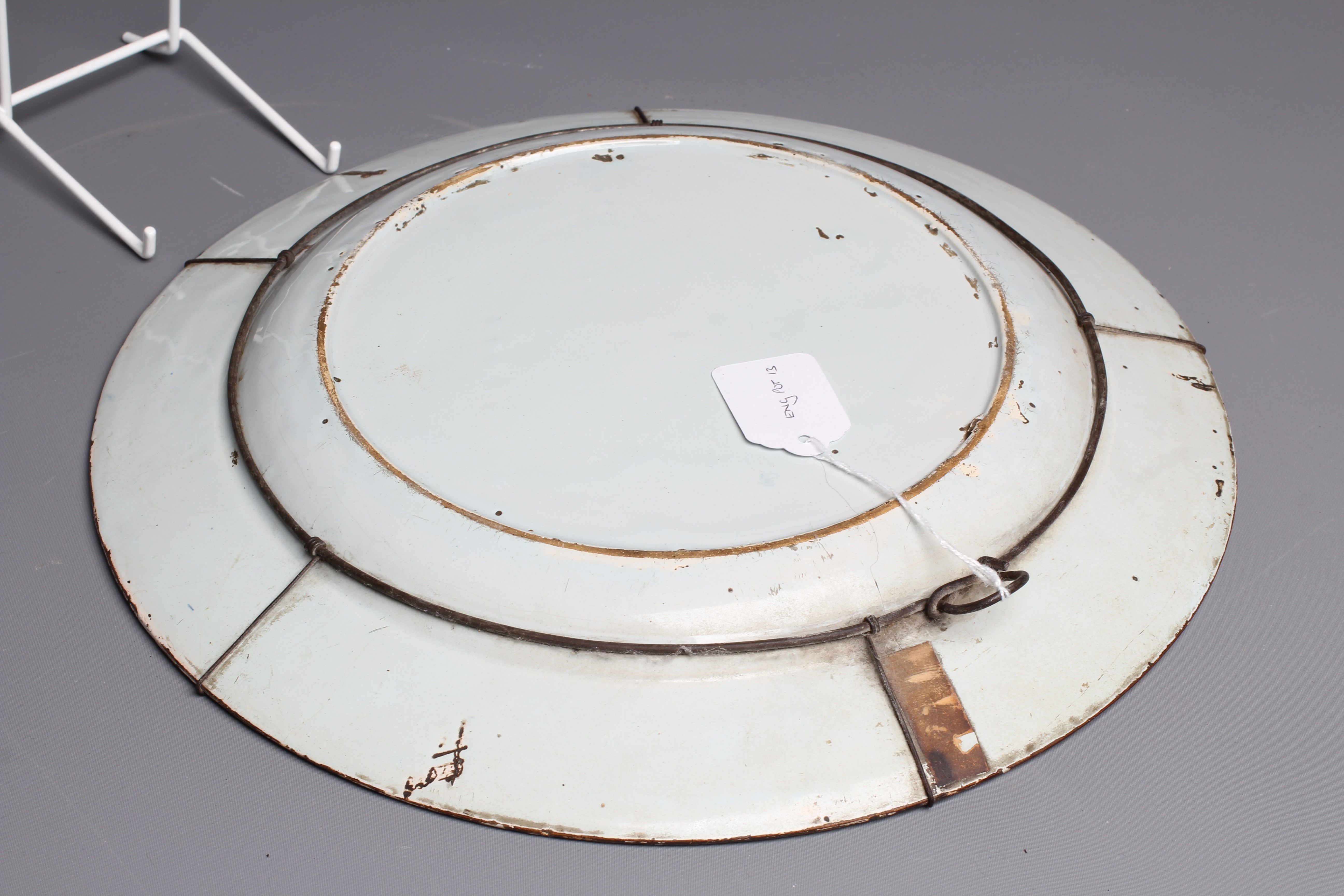 A LAMBETH DELFT CHARGER, c.1760, painted in blue, ochre, green and burnt orange with a large parrot Image