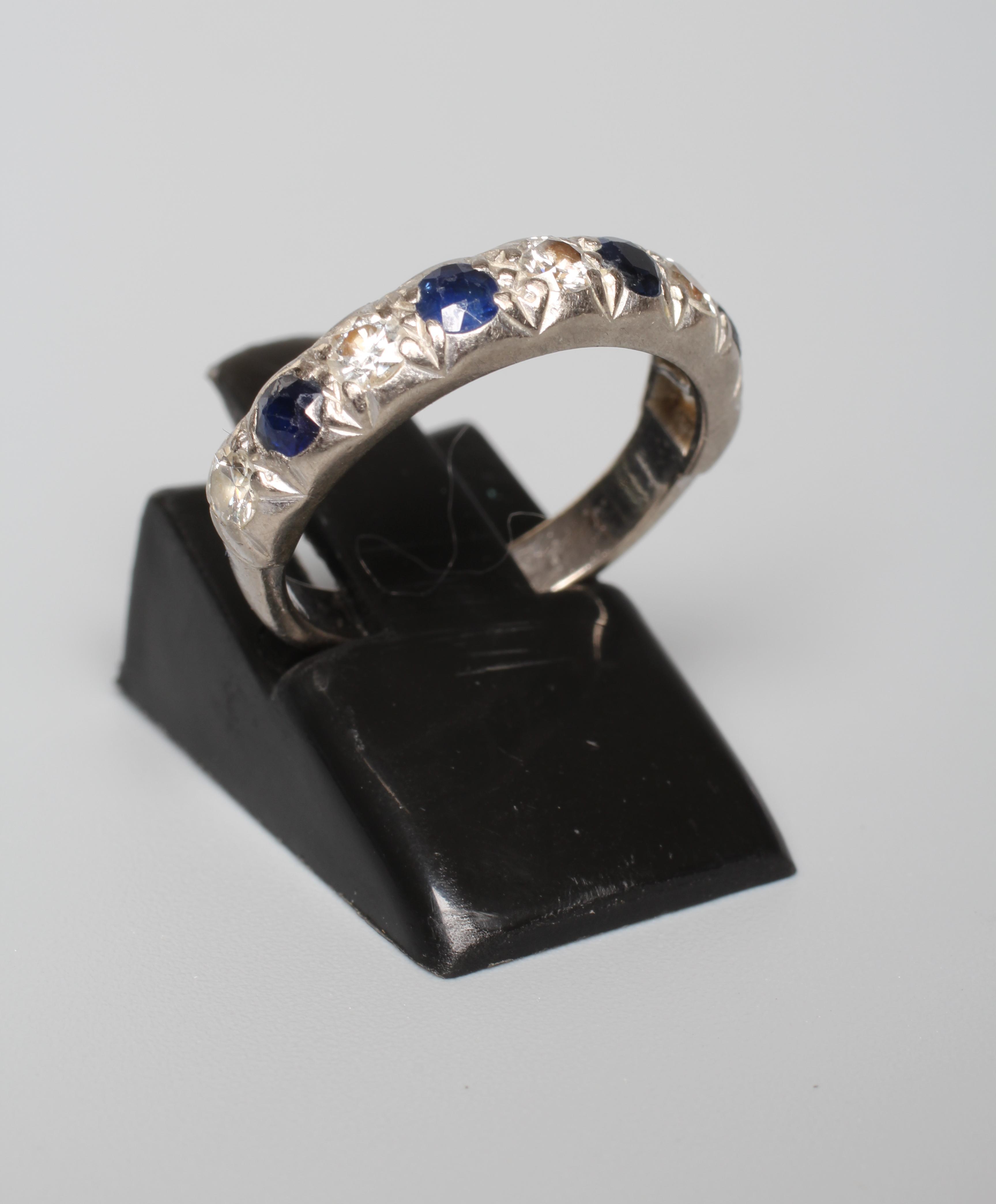 A NINE STONE SAPPHIRE AND DIAMOND HALF HOOP ETERNITY RING, the four sapphires and five diamonds in a Image