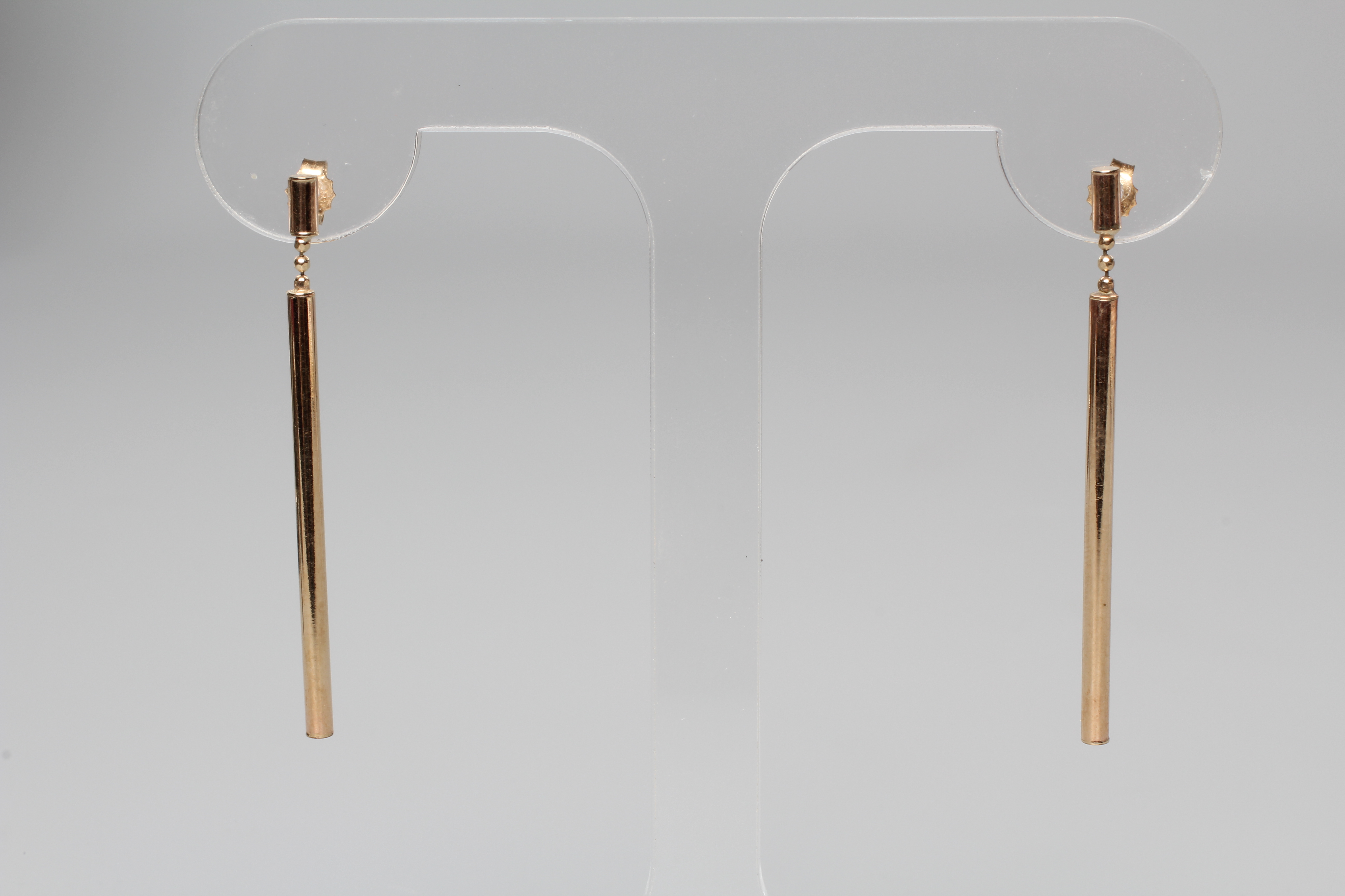 A PAIR OF DROP EAR STUDS, the 4cms long cylinders hung from three ball links and a further shorter Image