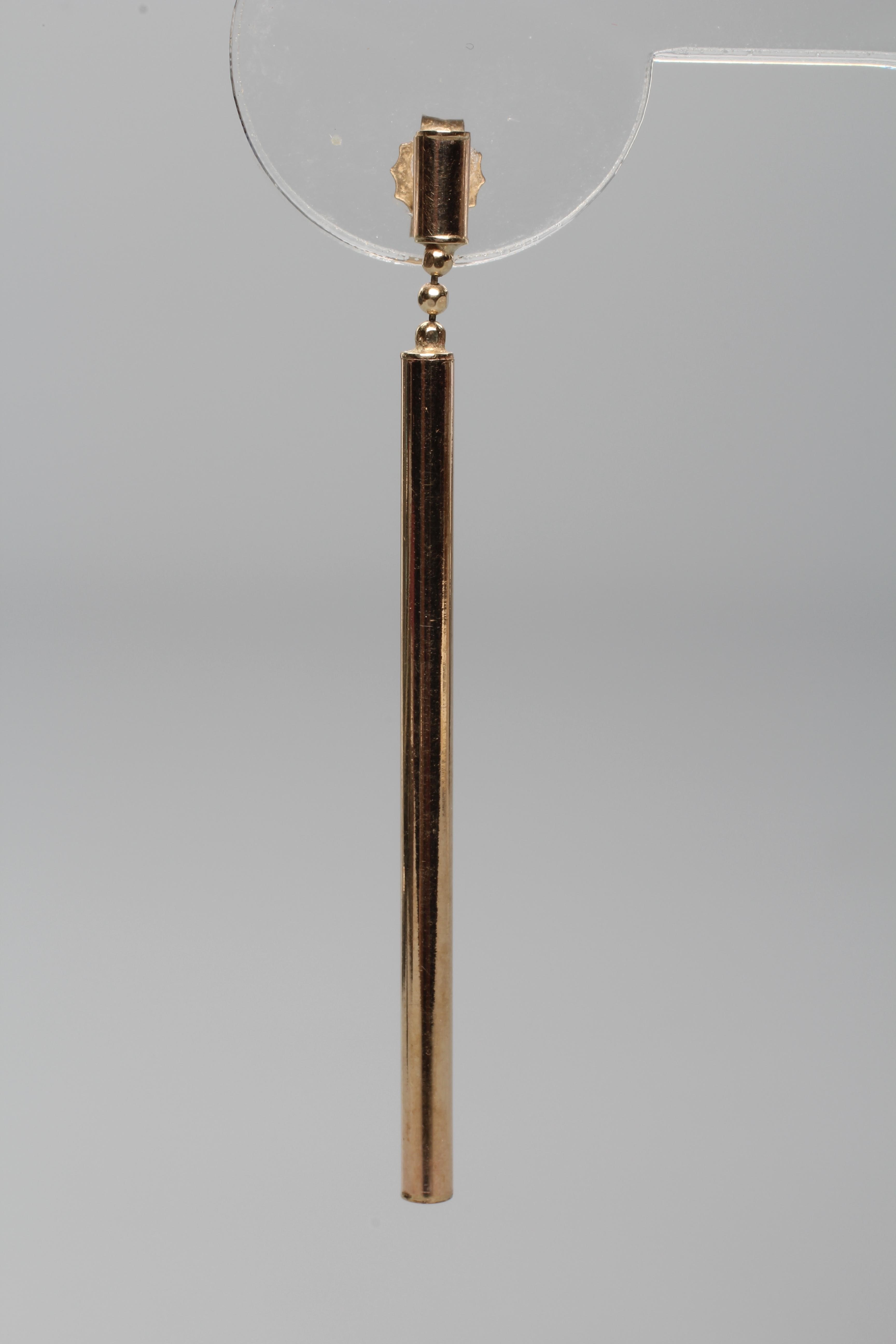 A PAIR OF DROP EAR STUDS, the 4cms long cylinders hung from three ball links and a further shorter Image