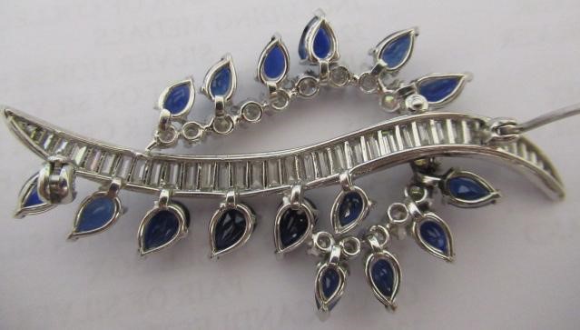 A SAPPHIRE AND DIAMOND COCKTAIL BROOCH of abstract leaf design Image