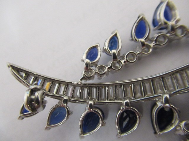 A SAPPHIRE AND DIAMOND COCKTAIL BROOCH of abstract leaf design Image