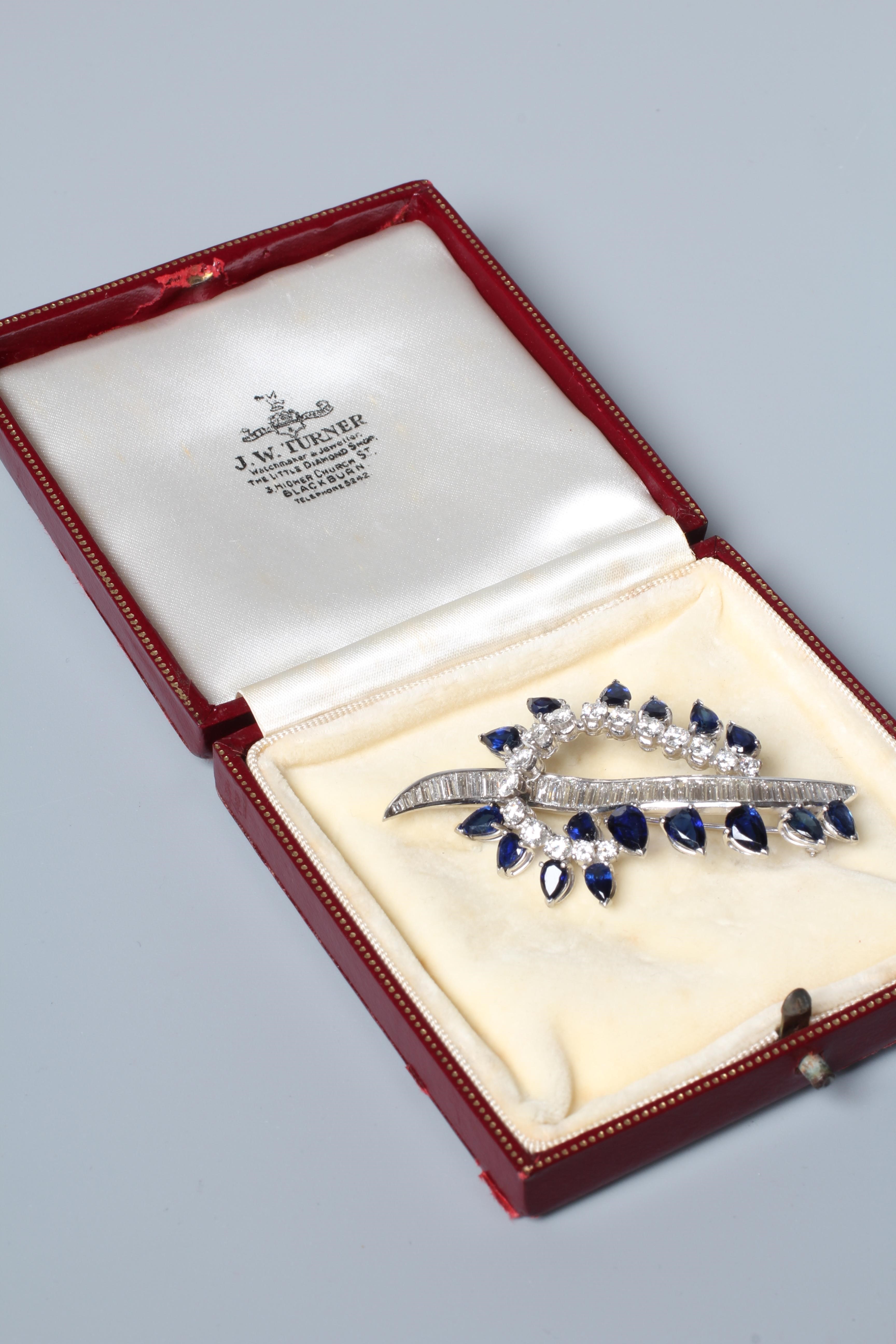 A SAPPHIRE AND DIAMOND COCKTAIL BROOCH of abstract leaf design Image