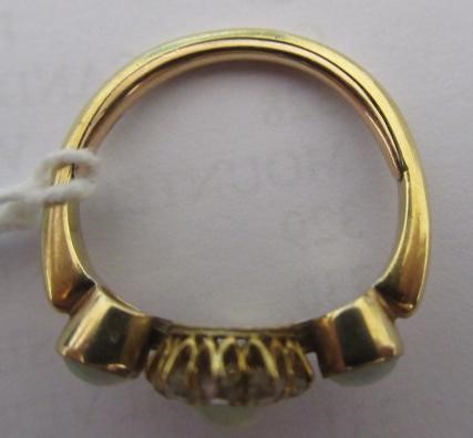AN EDWARDIAN OPAL AND DIAMOND DRESS RING, the central cluster on a knife edge bar flanked by two Image