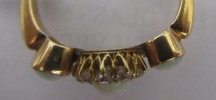 AN EDWARDIAN OPAL AND DIAMOND DRESS RING, the central cluster on a knife edge bar flanked by two Image