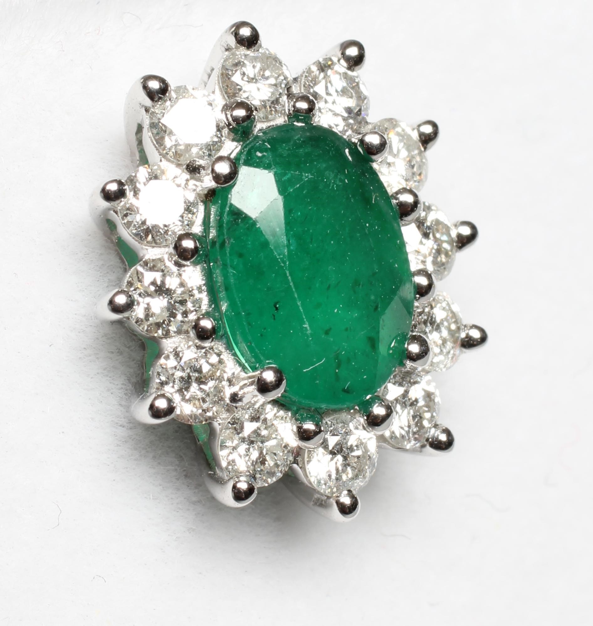 A PAIR OF EMERALD AND DIAMOND CLUSTER EAR STUDS, the oval facet cut emeralds claw set to borders, Image