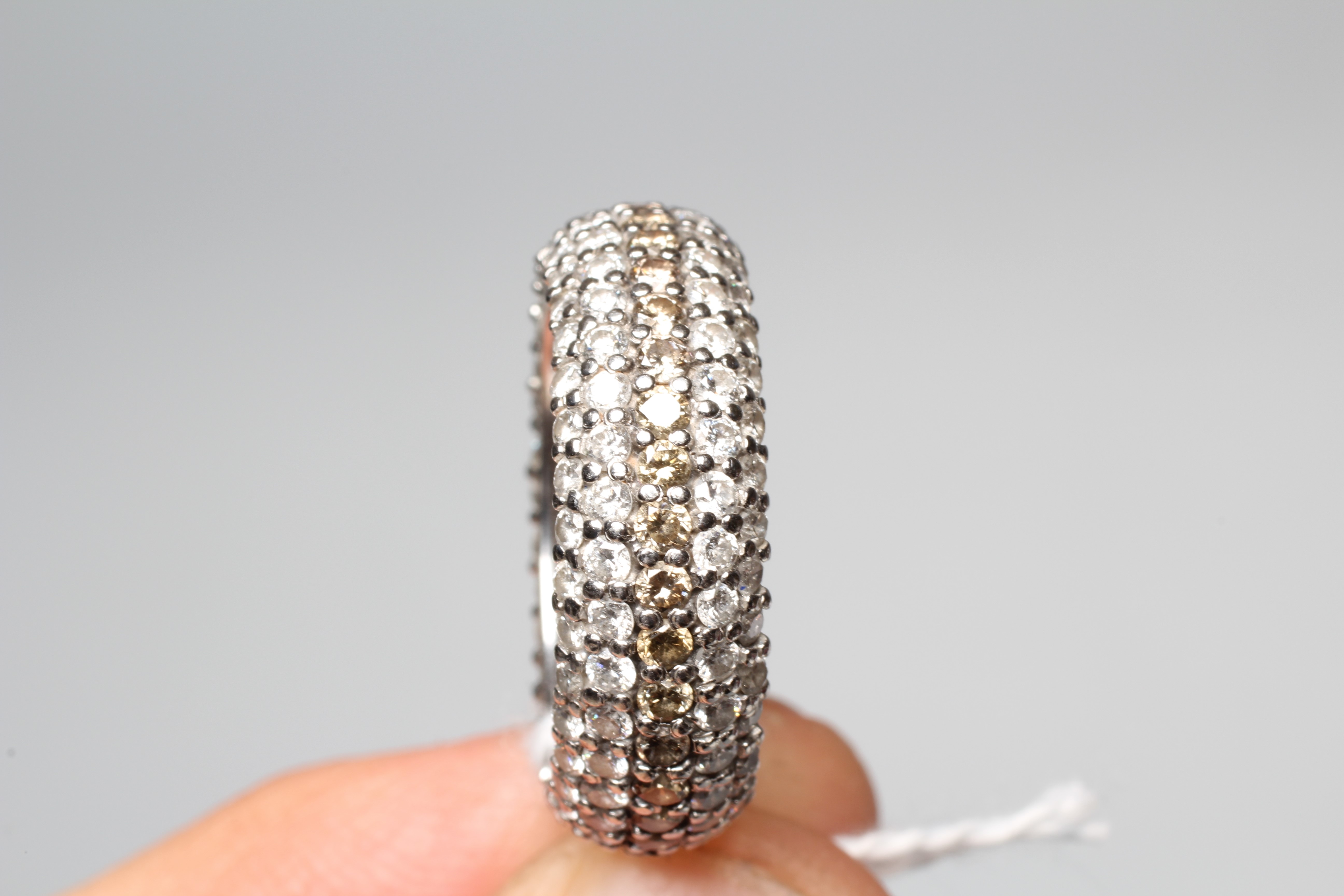 A FIVE ROW DIAMOND FULL ETERNITY DRESS RING, the central row of brown stones point set to borders of Image