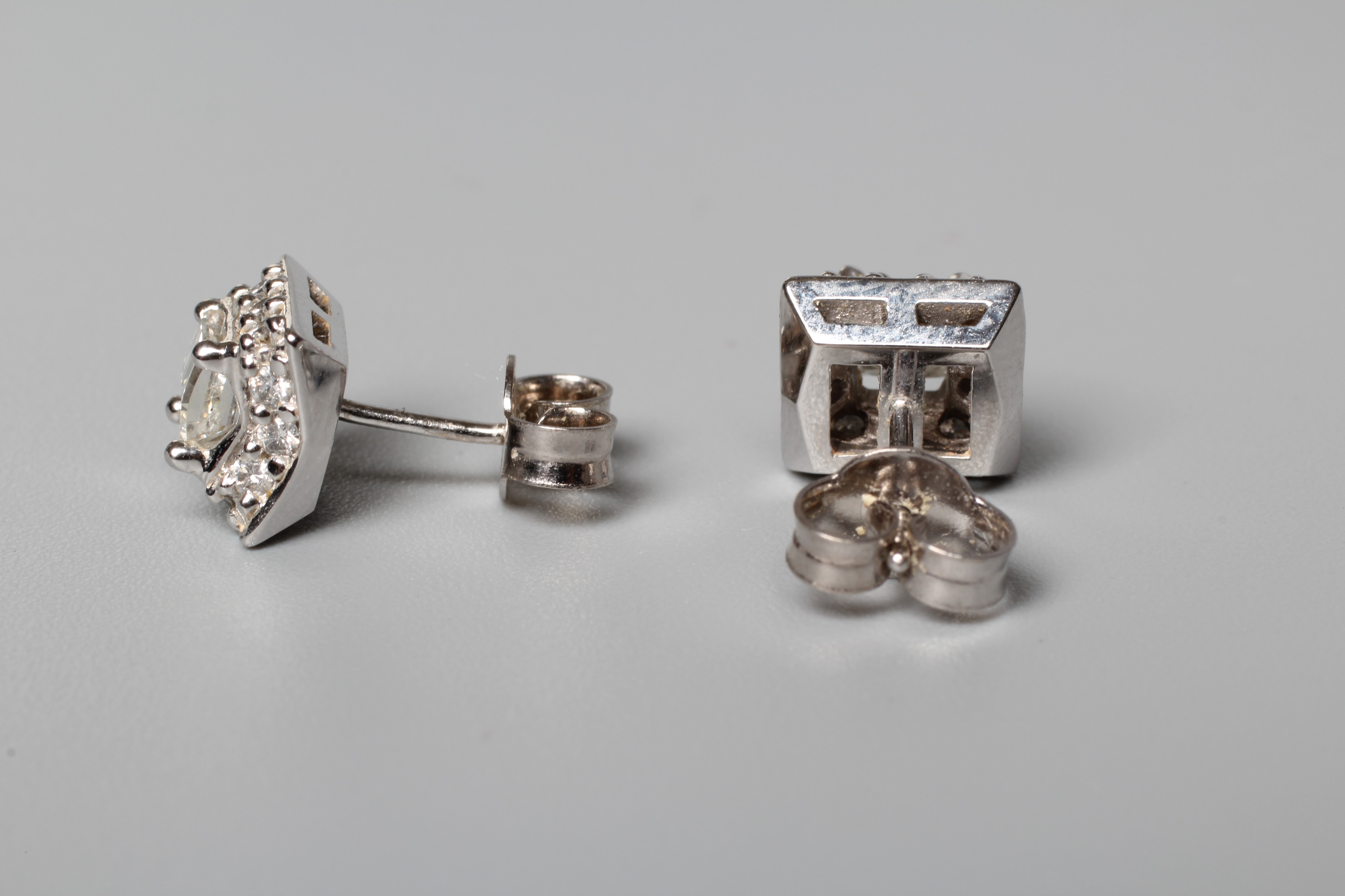 A PAIR OF DIAMOND EAR STUDS, the central square cut stones claw set to a border small round Image