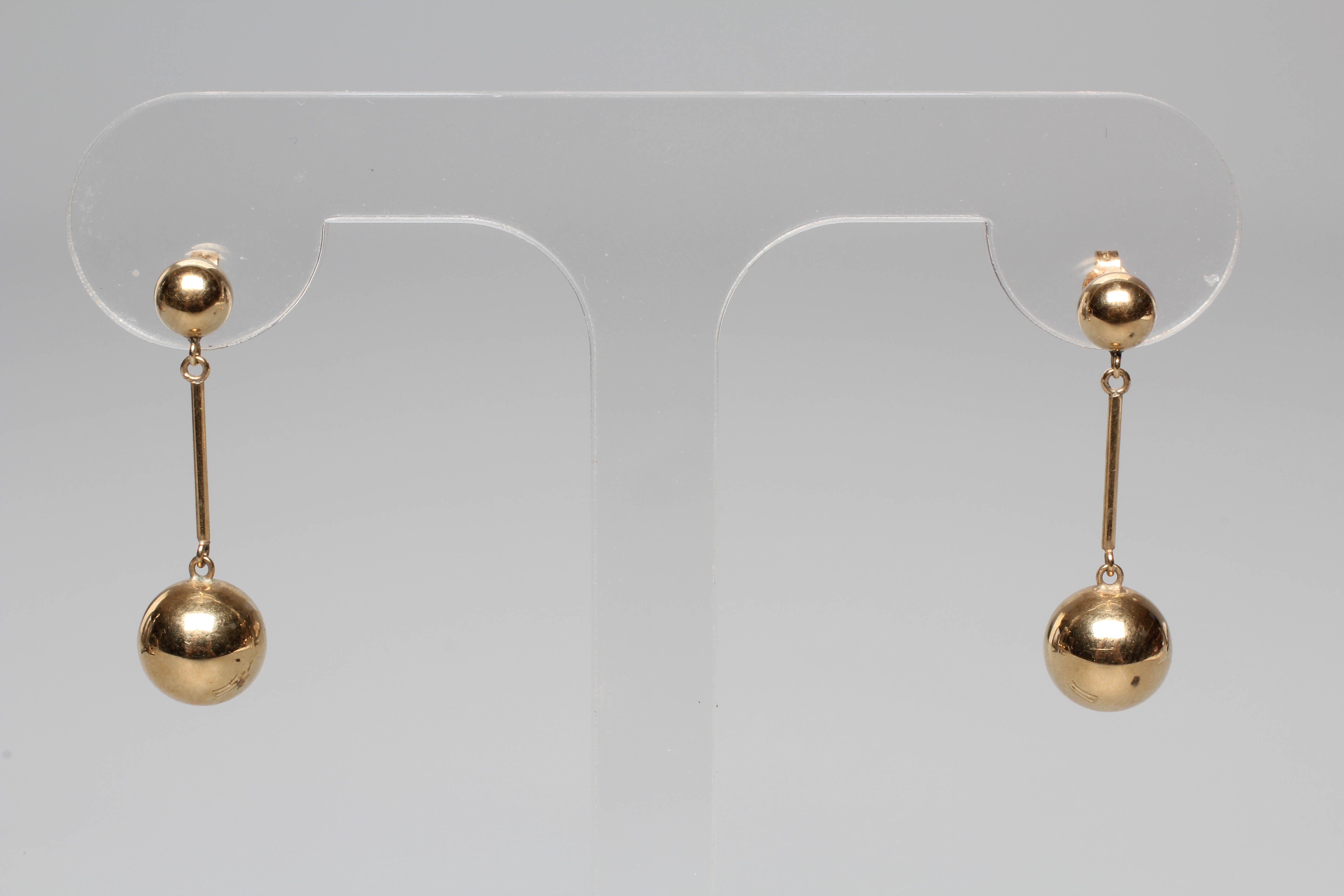 A PAIR OF DROP EAR STUDS, the cylindrical links hung with spheres and pendant from smaller ball Image