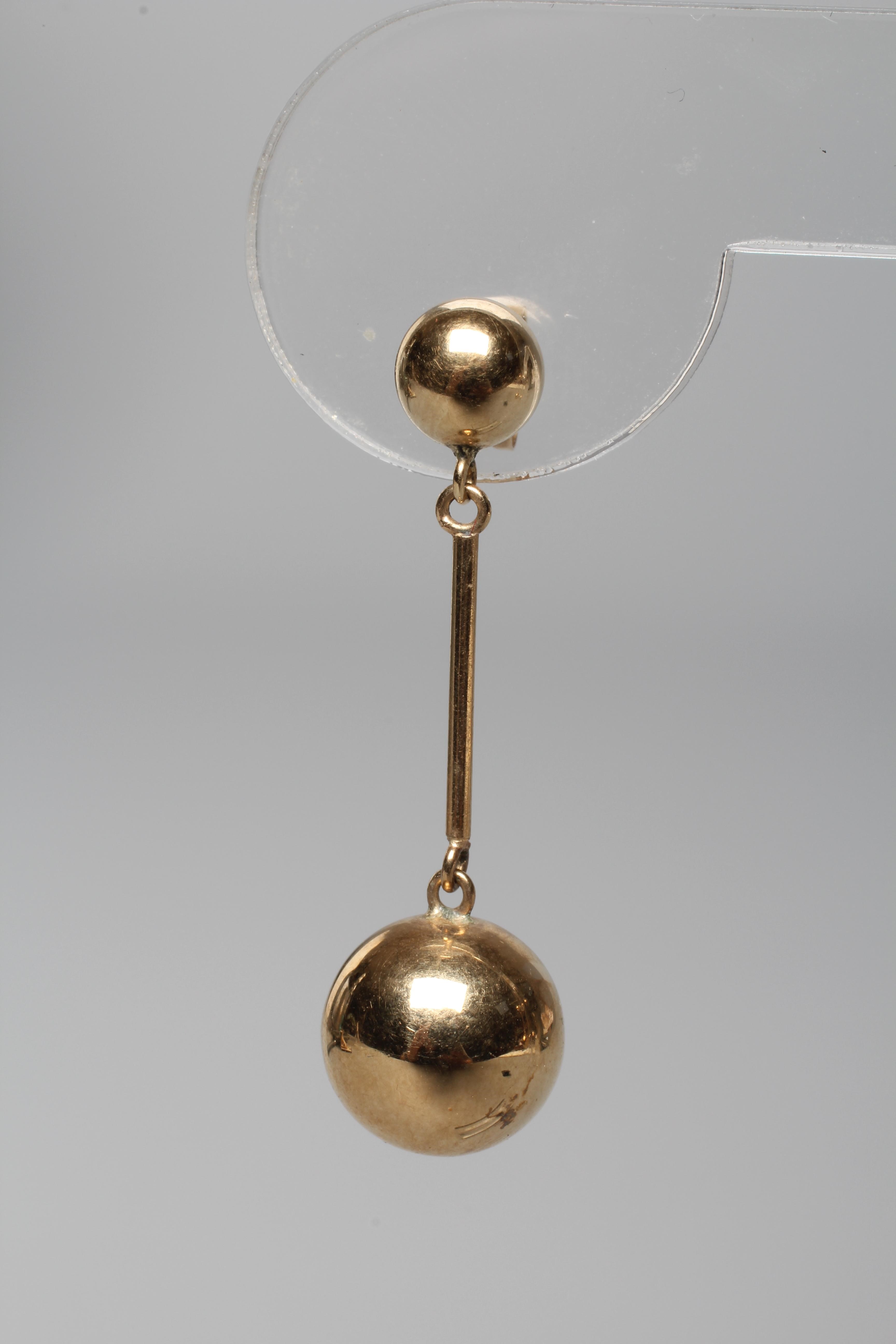 A PAIR OF DROP EAR STUDS, the cylindrical links hung with spheres and pendant from smaller ball Image