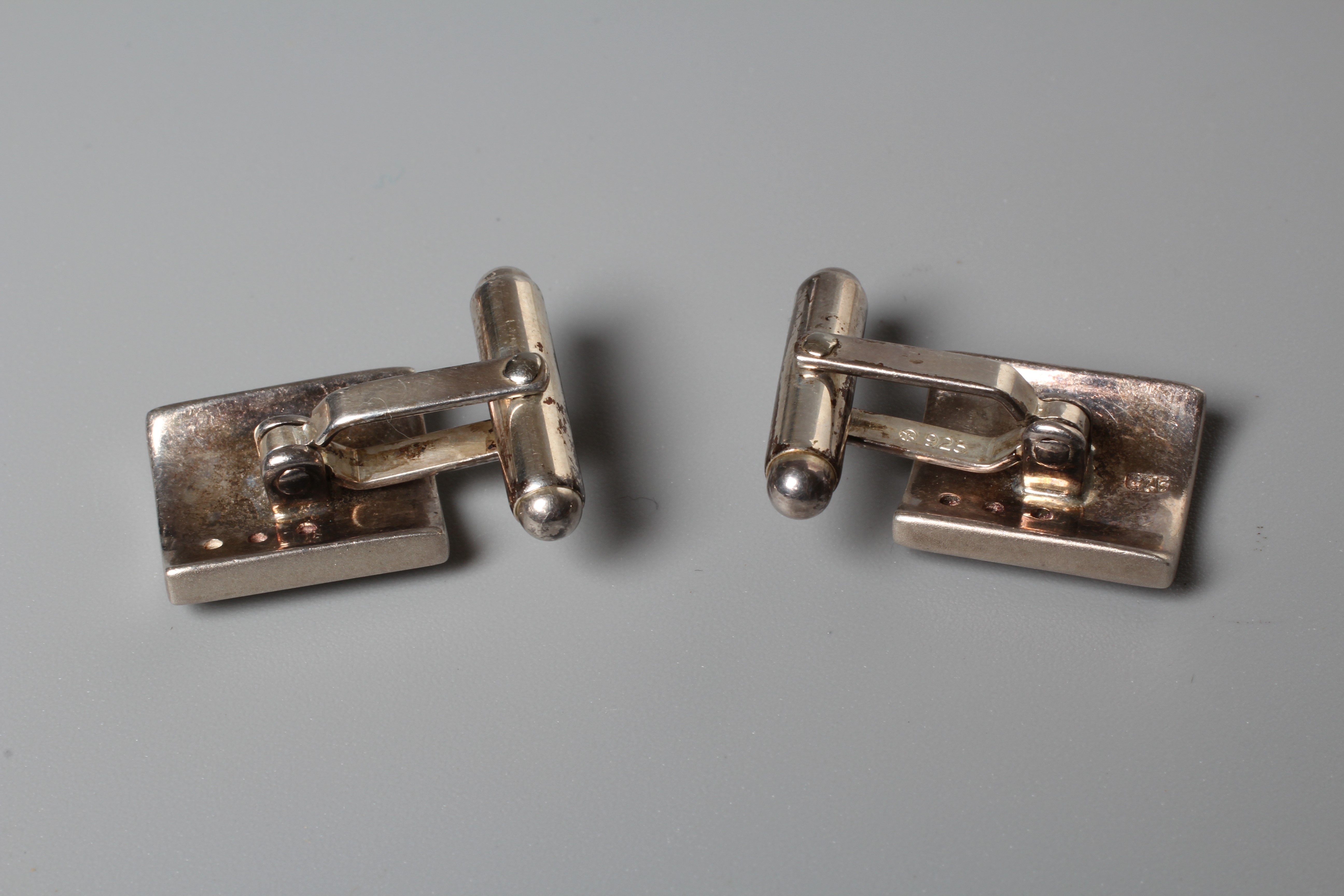 A PAIR OF SILVER CUFFLINKS, each matt polished oblong link set with three small diamonds, stamped Image