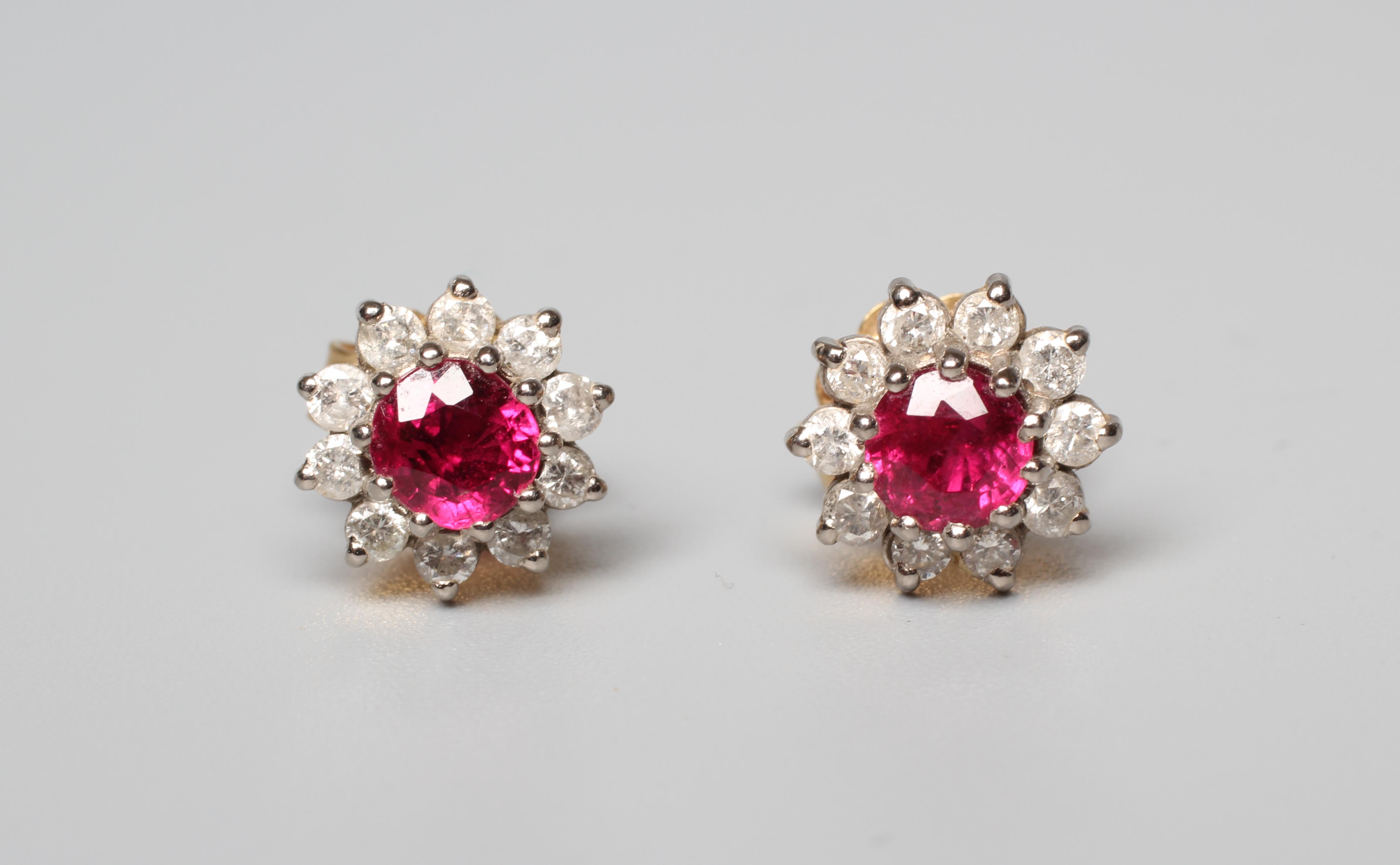 A PAIR OF RUBY AND DIAMOND CLUSTER EAR STUDS, the facet cut circular rubies claw set to borders of Image