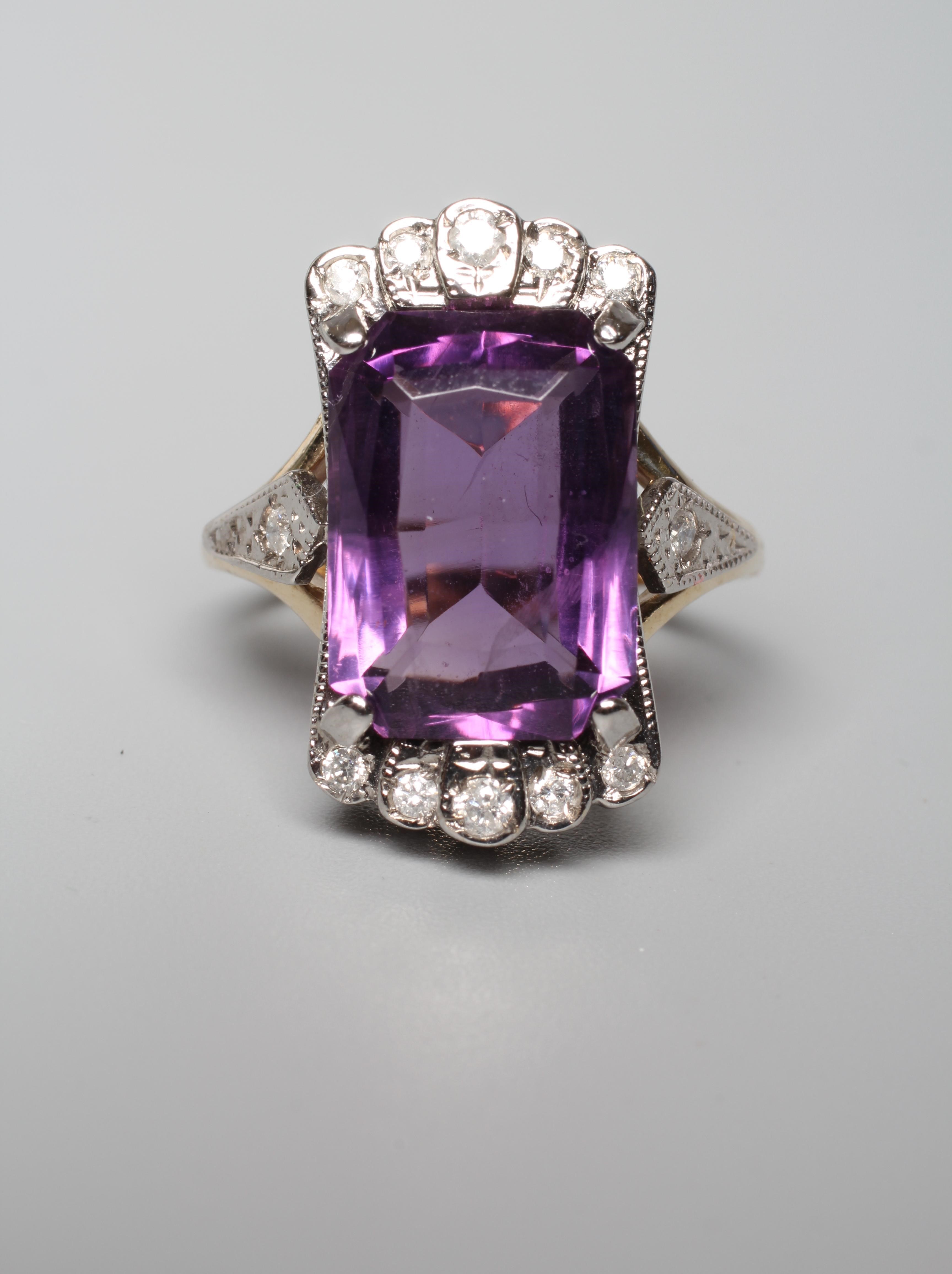 AN AMETHYST AND DIAMOND COCKTAIL RING, the emerald cut amethyst claw set to diamond angles and Image