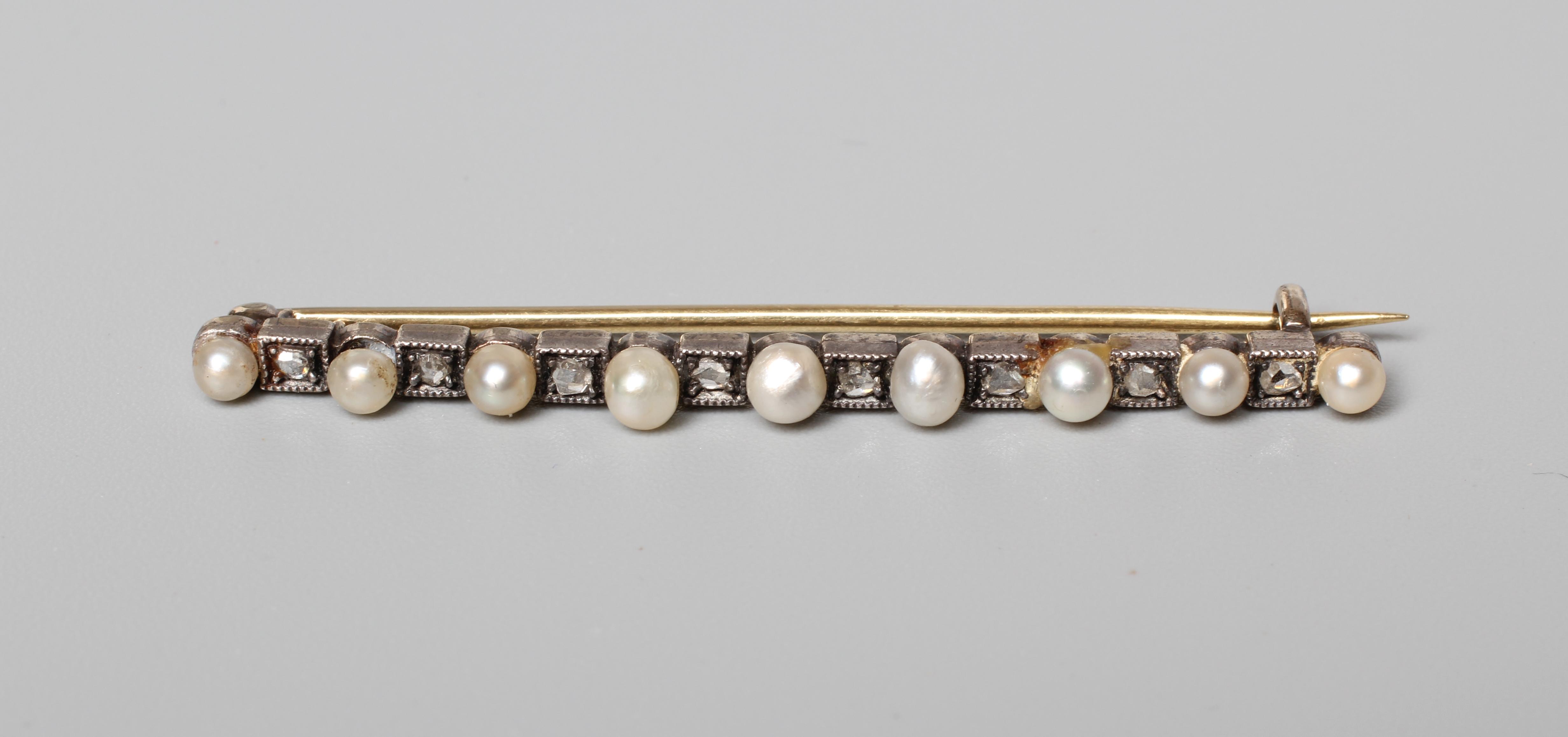 A VICTORIAN DIAMOND AND PEARL BAR BROOCH, the nine peg set pearls with eight rose cut diamonds Image