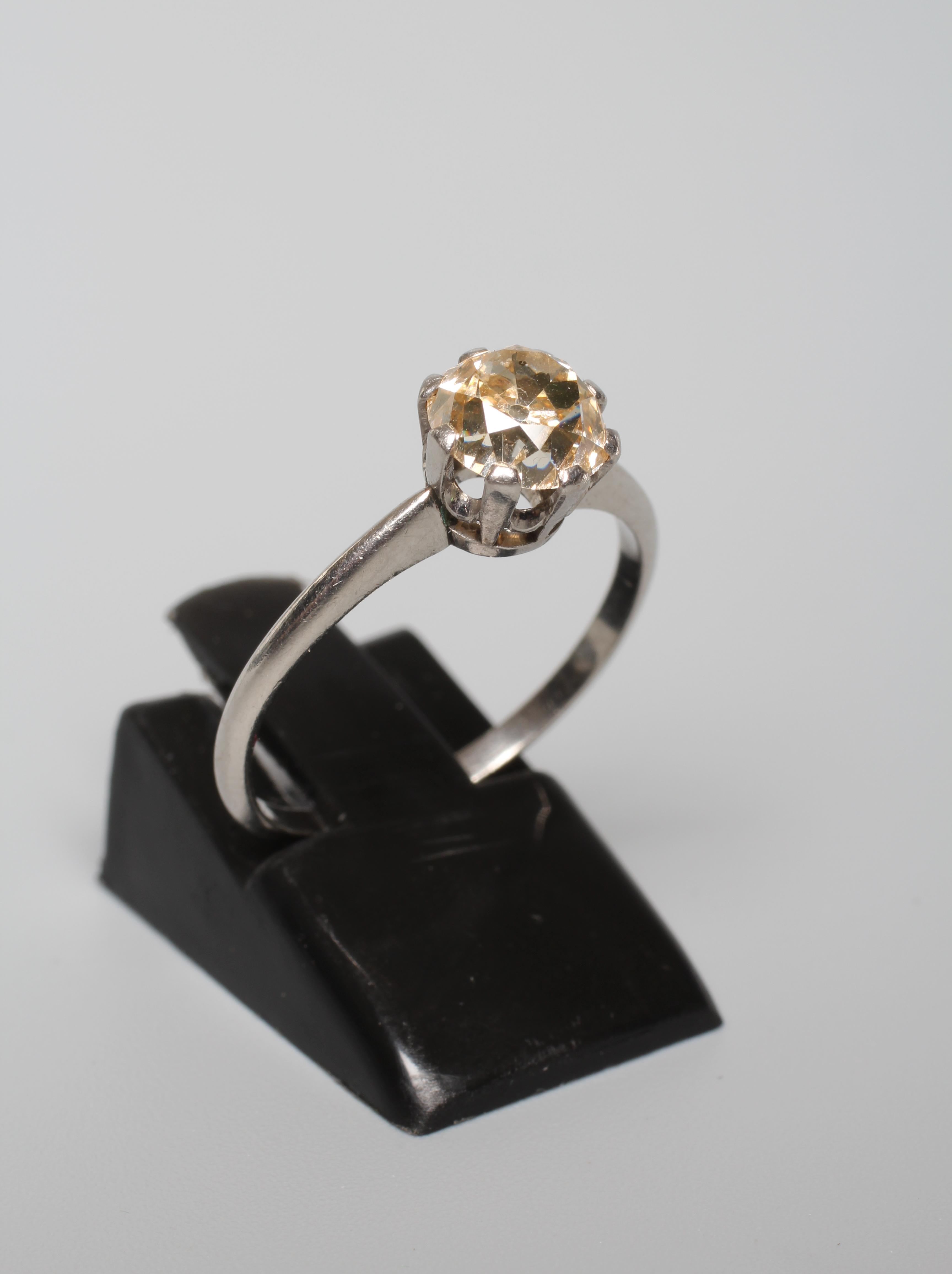 A SOLITAIRE DIAMOND RING, the old cut stone of approximately 1.25cts claw set to a plain unmarked Image