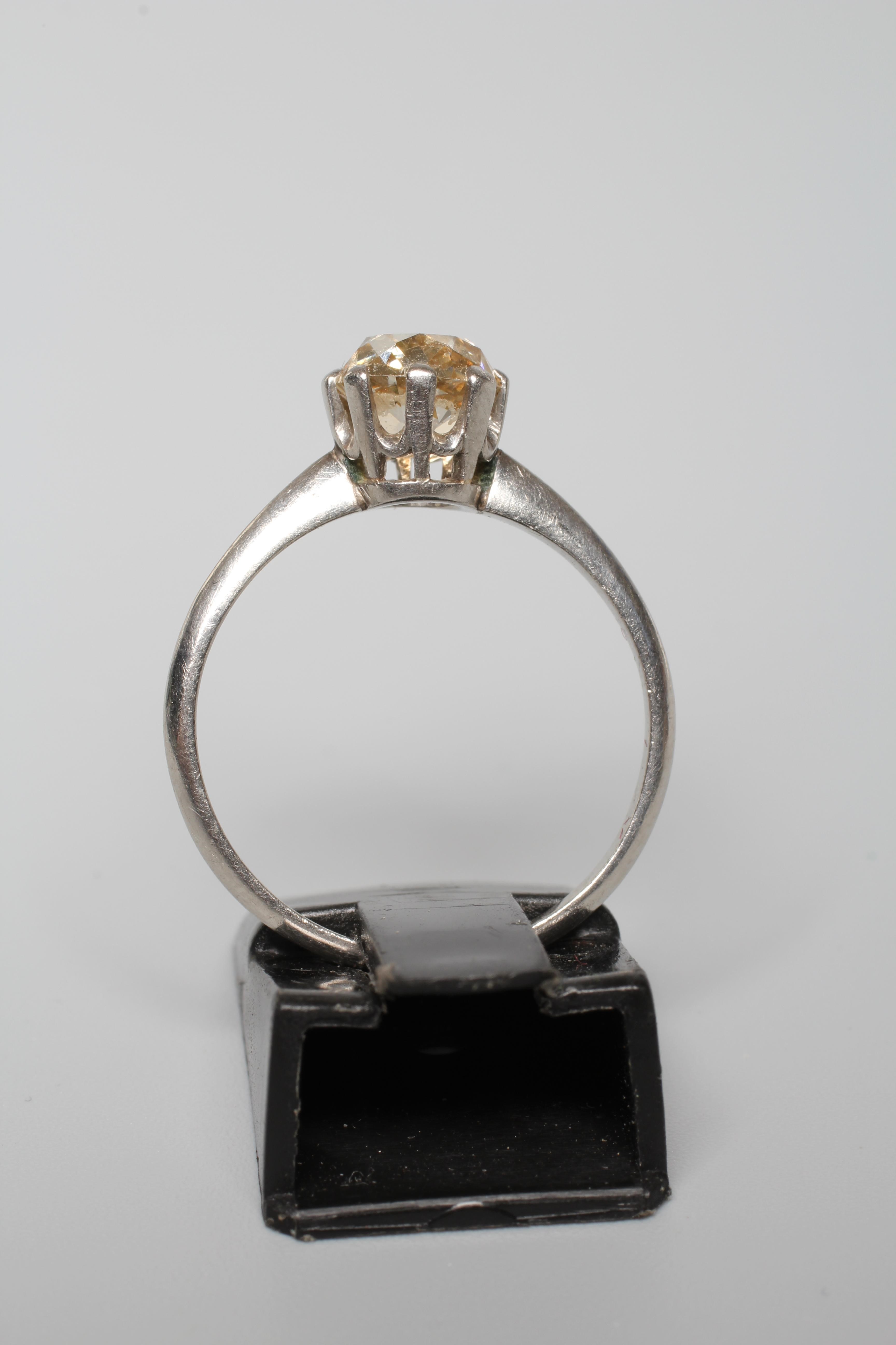 A SOLITAIRE DIAMOND RING, the old cut stone of approximately 1.25cts claw set to a plain unmarked Image