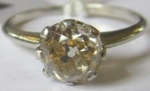 A SOLITAIRE DIAMOND RING, the old cut stone of approximately 1.25cts claw set to a plain unmarked Image