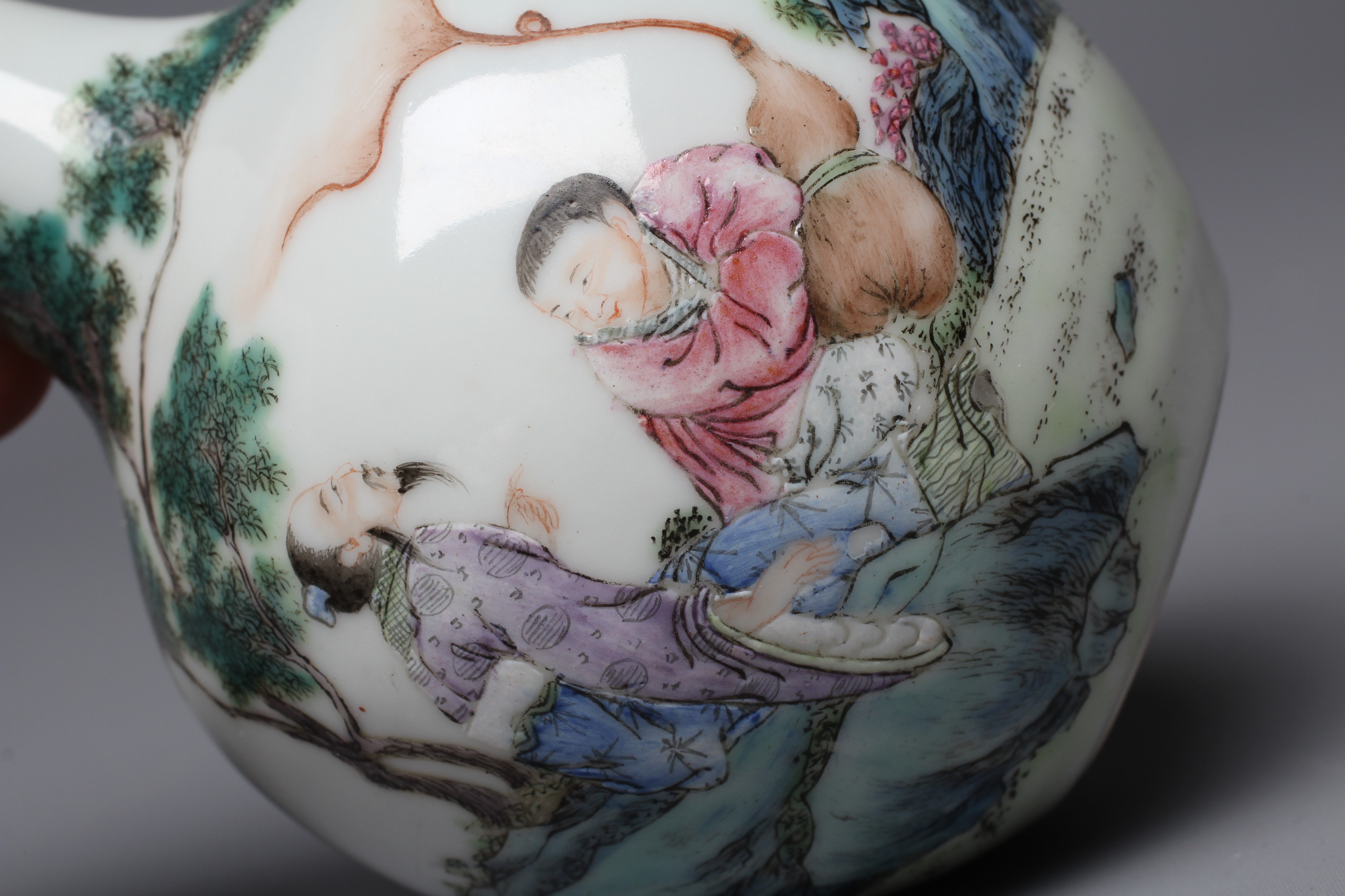 A CHINESE PORCELAIN SMALL BOTTLE VASE painted in coloured enamels with two figures seated beneath Image