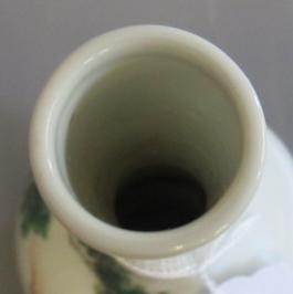 A CHINESE PORCELAIN SMALL BOTTLE VASE painted in coloured enamels with two figures seated beneath Image