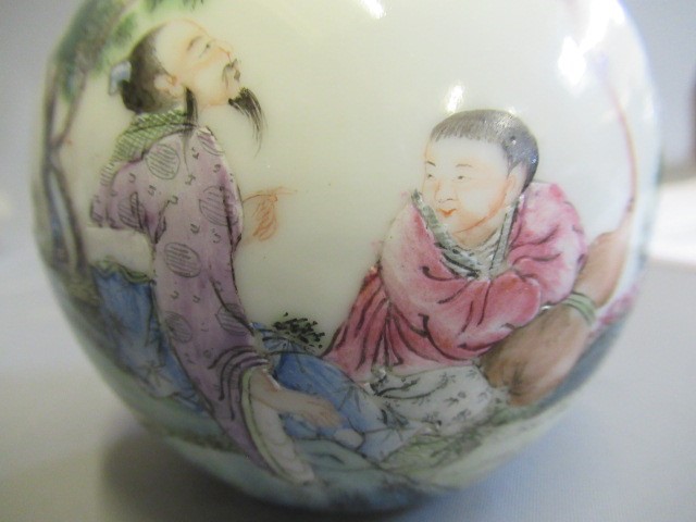A CHINESE PORCELAIN SMALL BOTTLE VASE painted in coloured enamels with two figures seated beneath Image