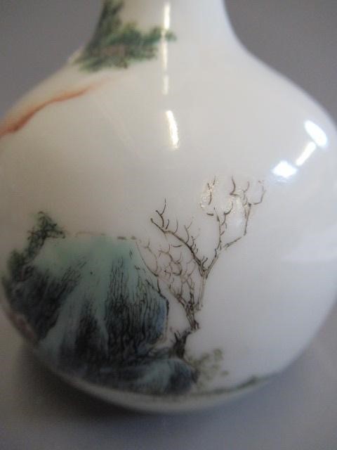 A CHINESE PORCELAIN SMALL BOTTLE VASE painted in coloured enamels with two figures seated beneath Image