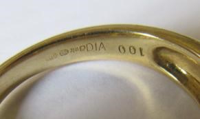 A SEVEN STONE DIAMOND HALF HOOP RING, the graduated round brilliants point set to a plain 18ct gold Image