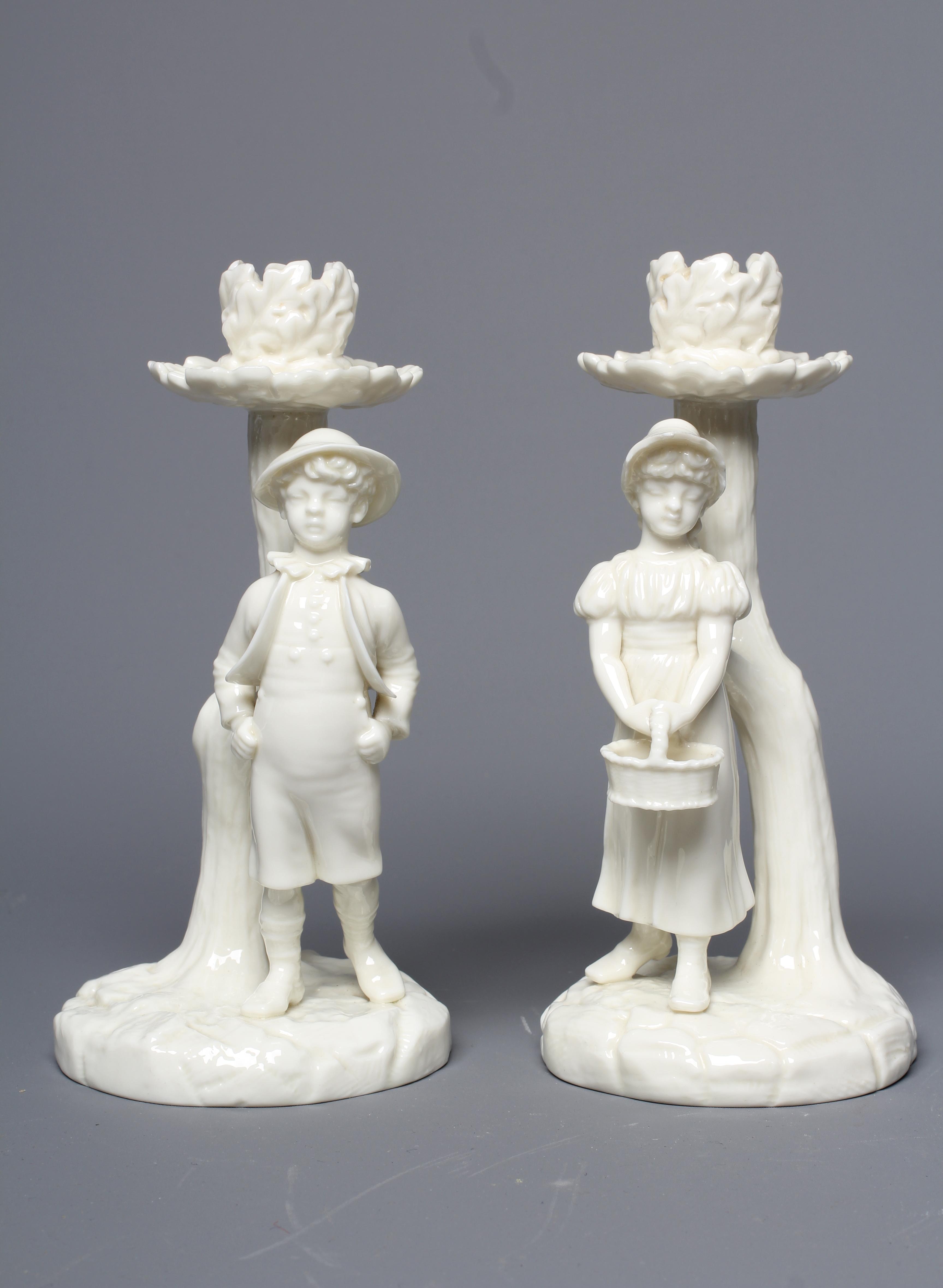 A PAIR OF VICTORIAN ROYAL WORCESTER BLANC DE CHINE FIGURAL CANDLESTICKS Image
