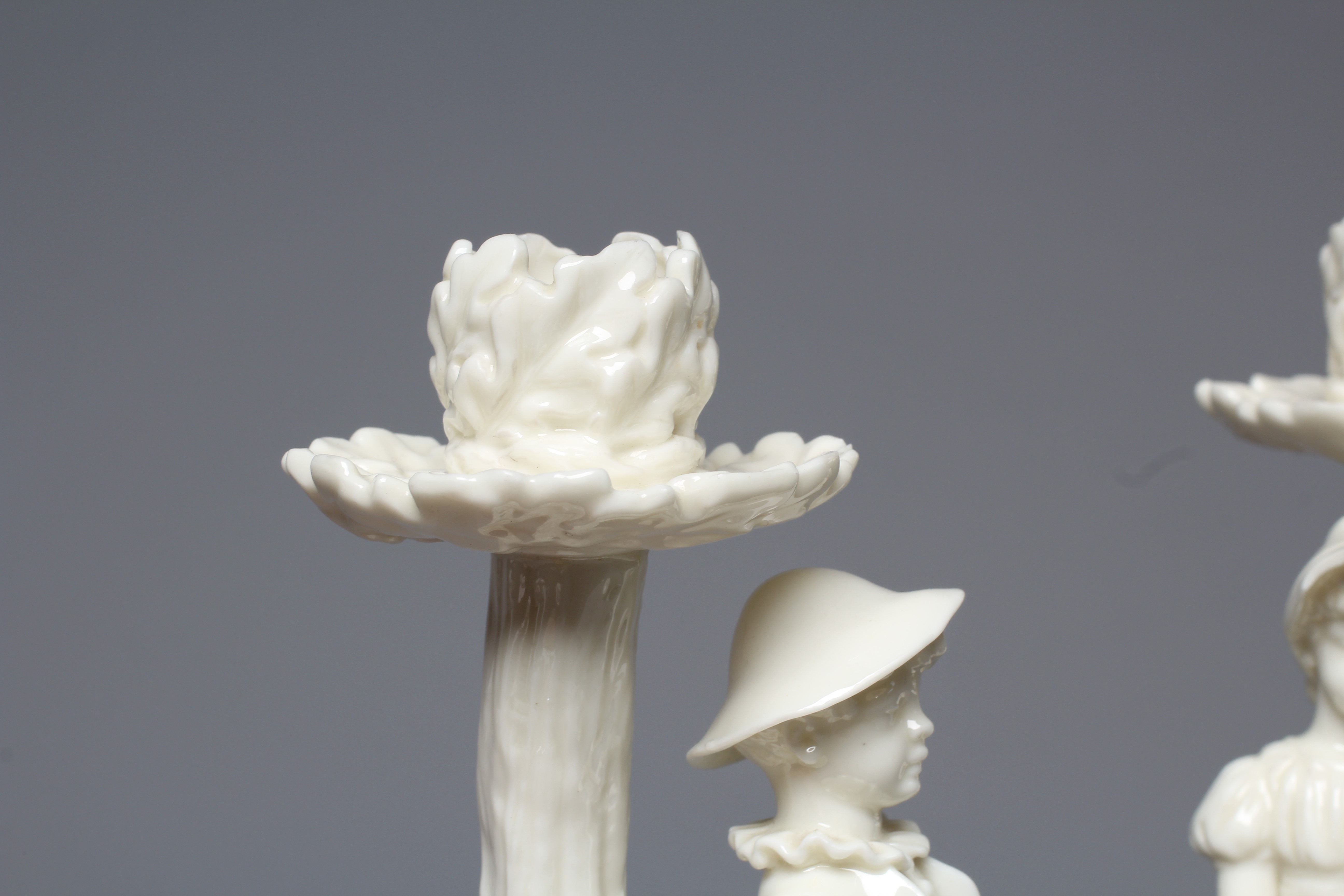 A PAIR OF VICTORIAN ROYAL WORCESTER BLANC DE CHINE FIGURAL CANDLESTICKS Image