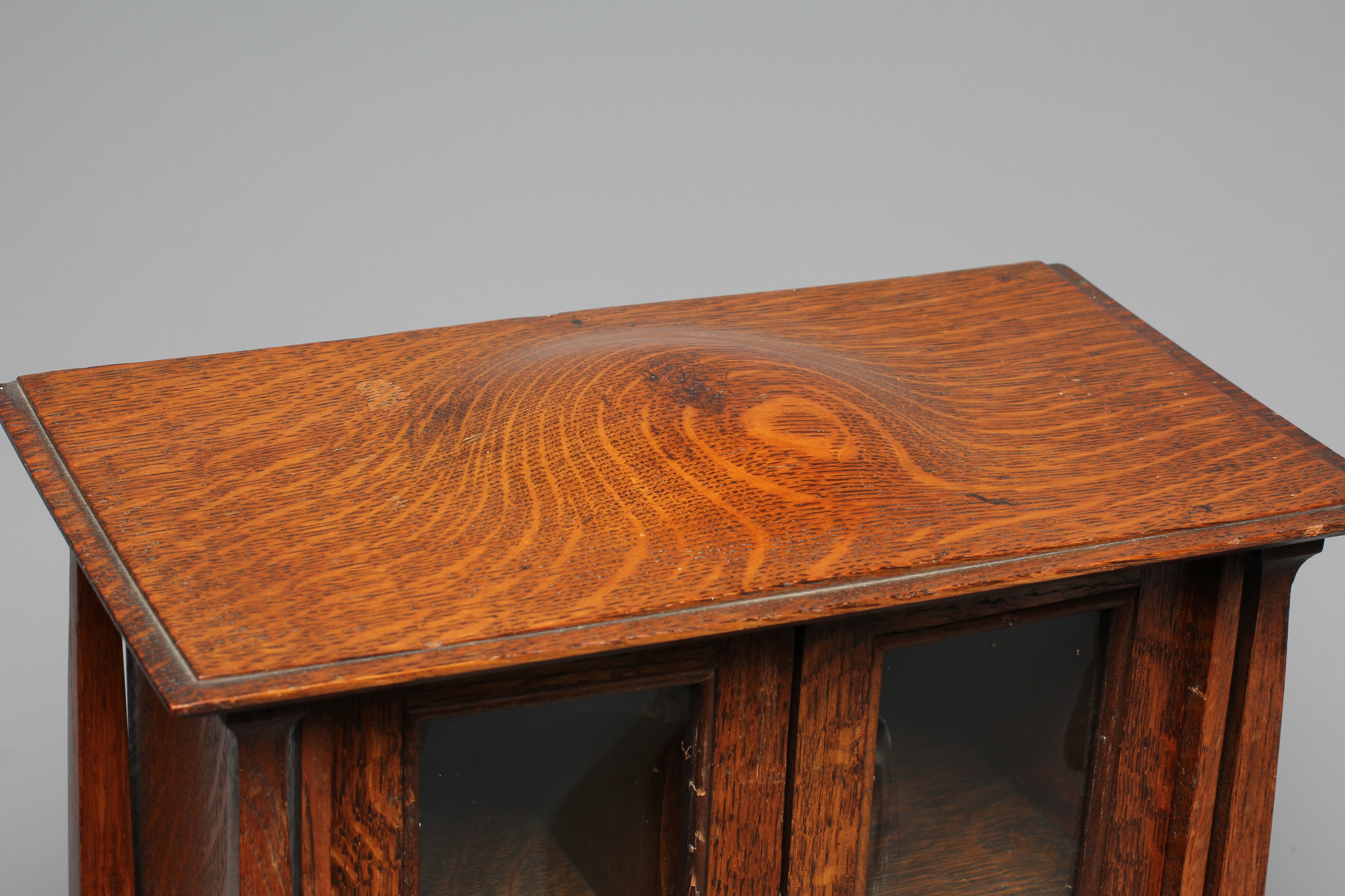 AN ARTS AND CRAFTS OAK SMOKER'S CABINET Image