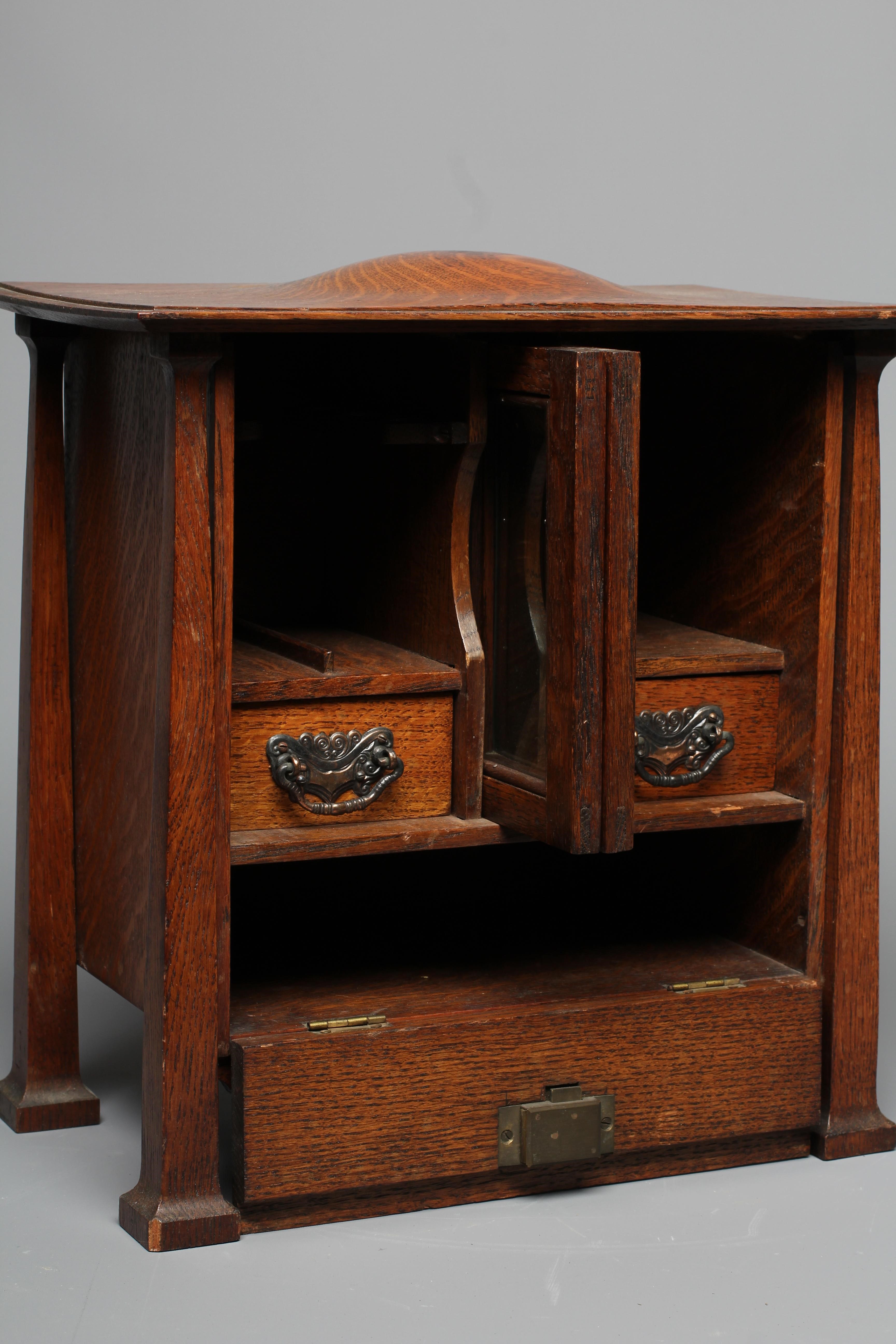 AN ARTS AND CRAFTS OAK SMOKER'S CABINET Image