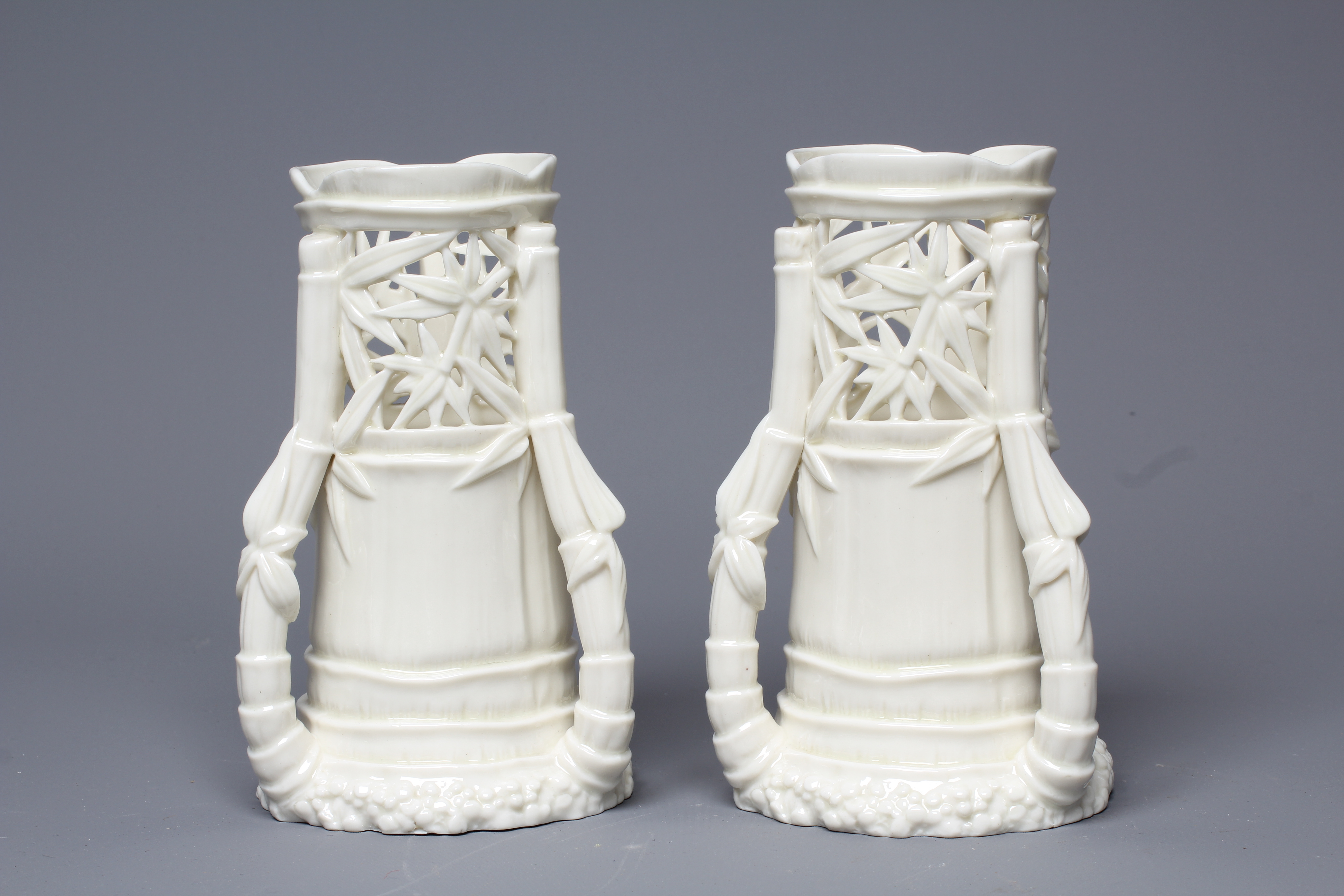 A PAIR OF VICTORIAN ROYAL WORCESTER BLANC DE CHINE BAMBOO SPILL VASES, 1883, the leaf pierced rims Image