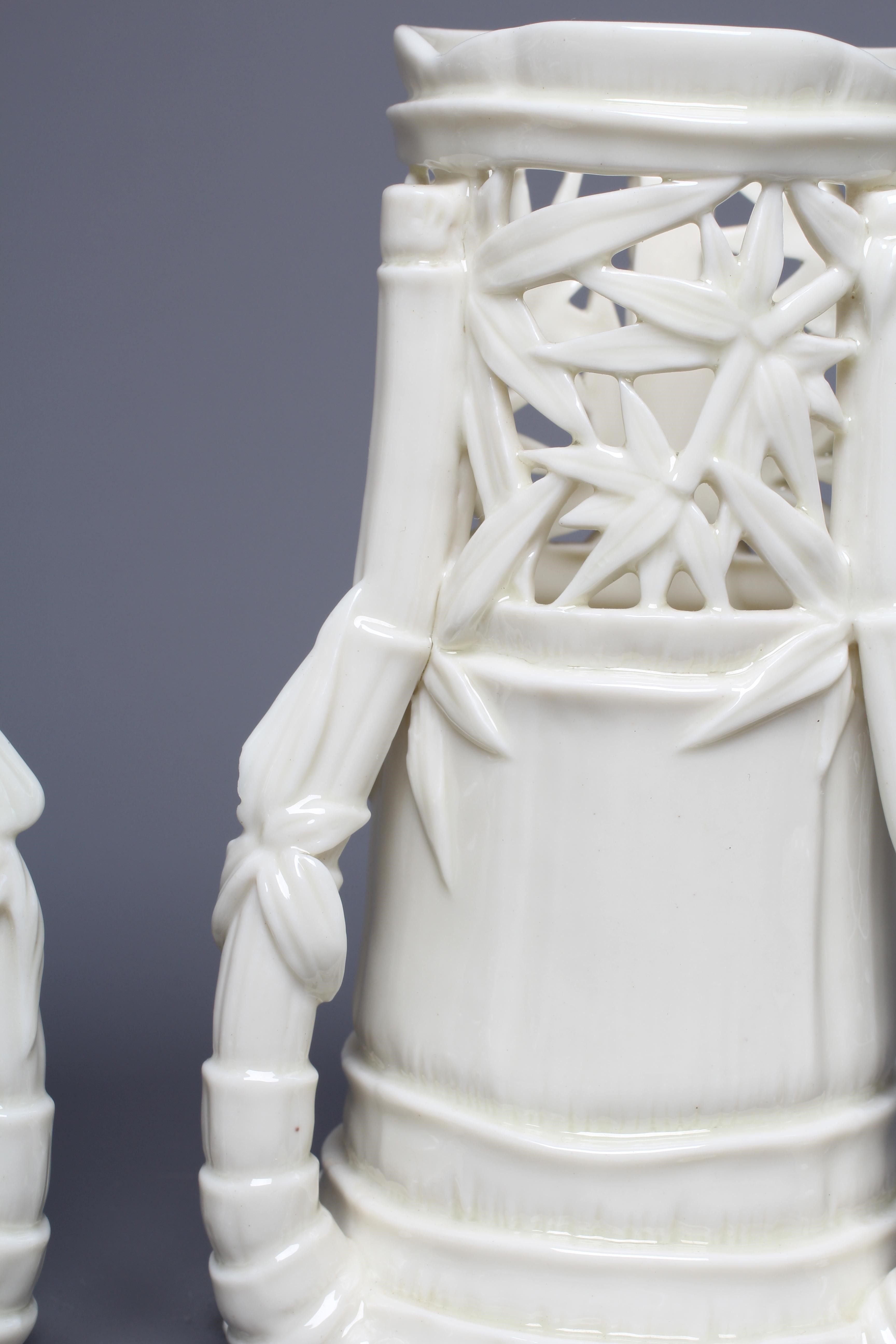 A PAIR OF VICTORIAN ROYAL WORCESTER BLANC DE CHINE BAMBOO SPILL VASES, 1883, the leaf pierced rims Image