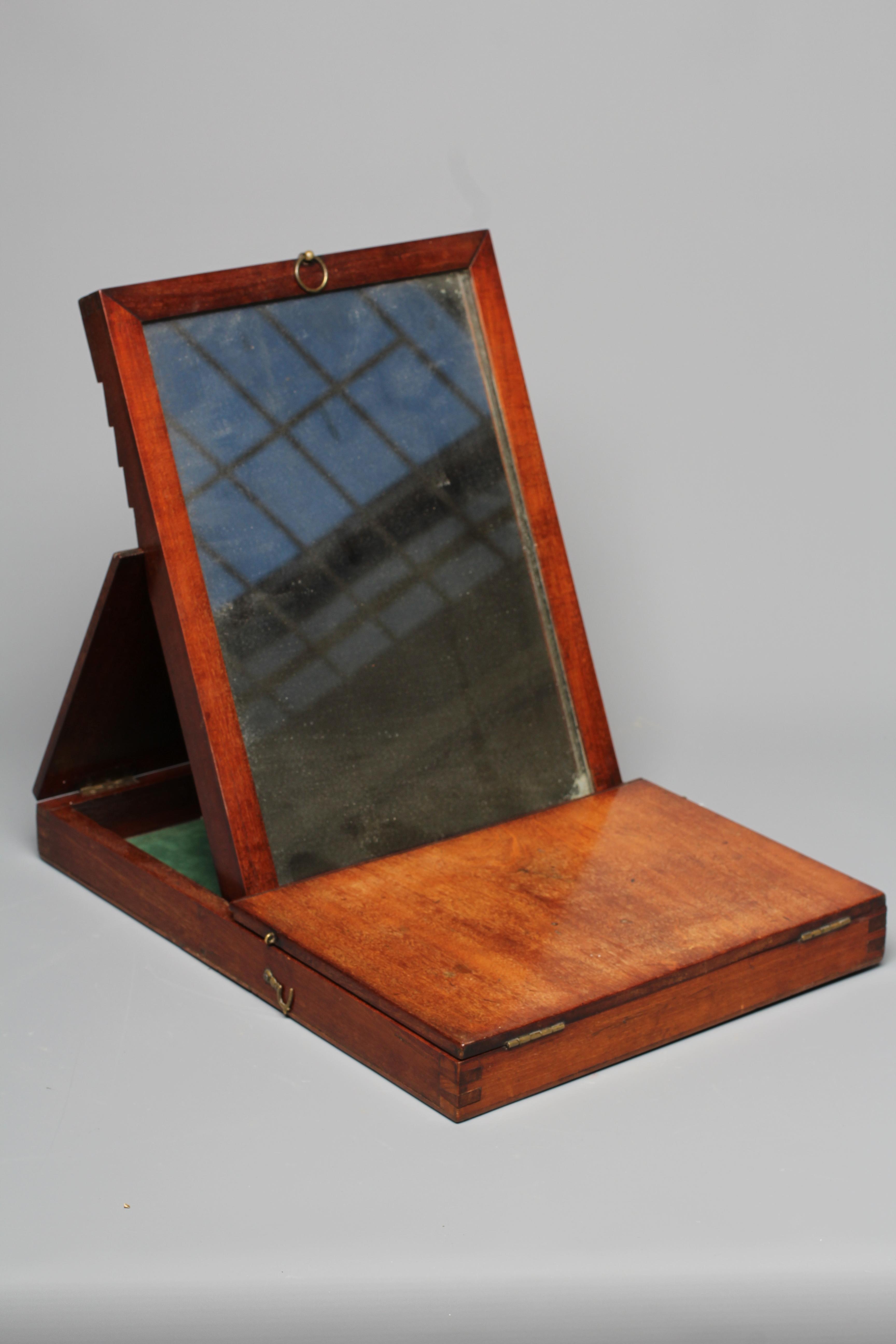 A 19TH CENTURY FOLDING CAMPAIGN MIRROR, the oblong plate in a moulded frame folding into a Image