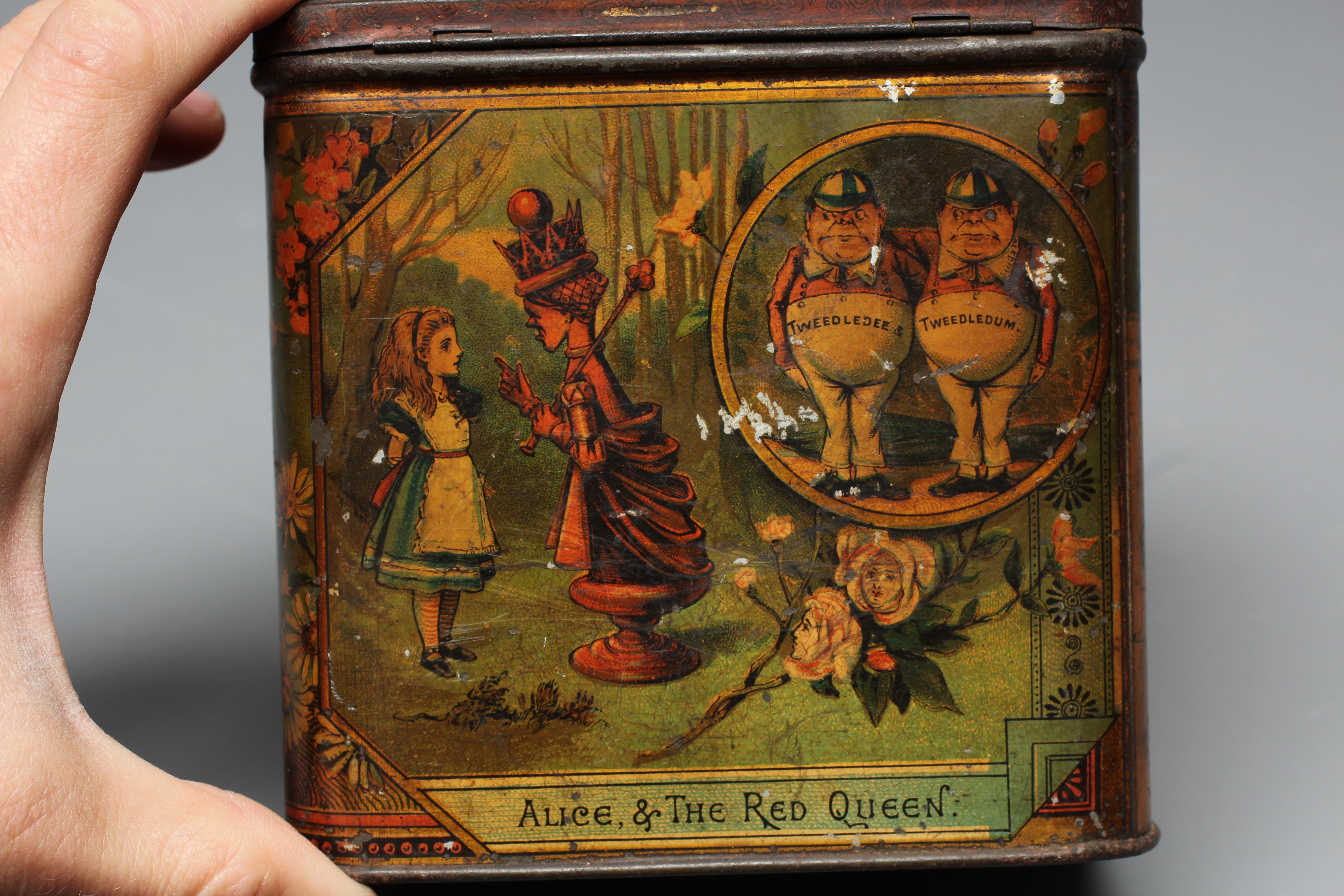 A VICTORIAN 'ALICE IN WONDERLAND' BISCUIT TIN BY W & R JACOBS LTD. of rounded oblong form Image