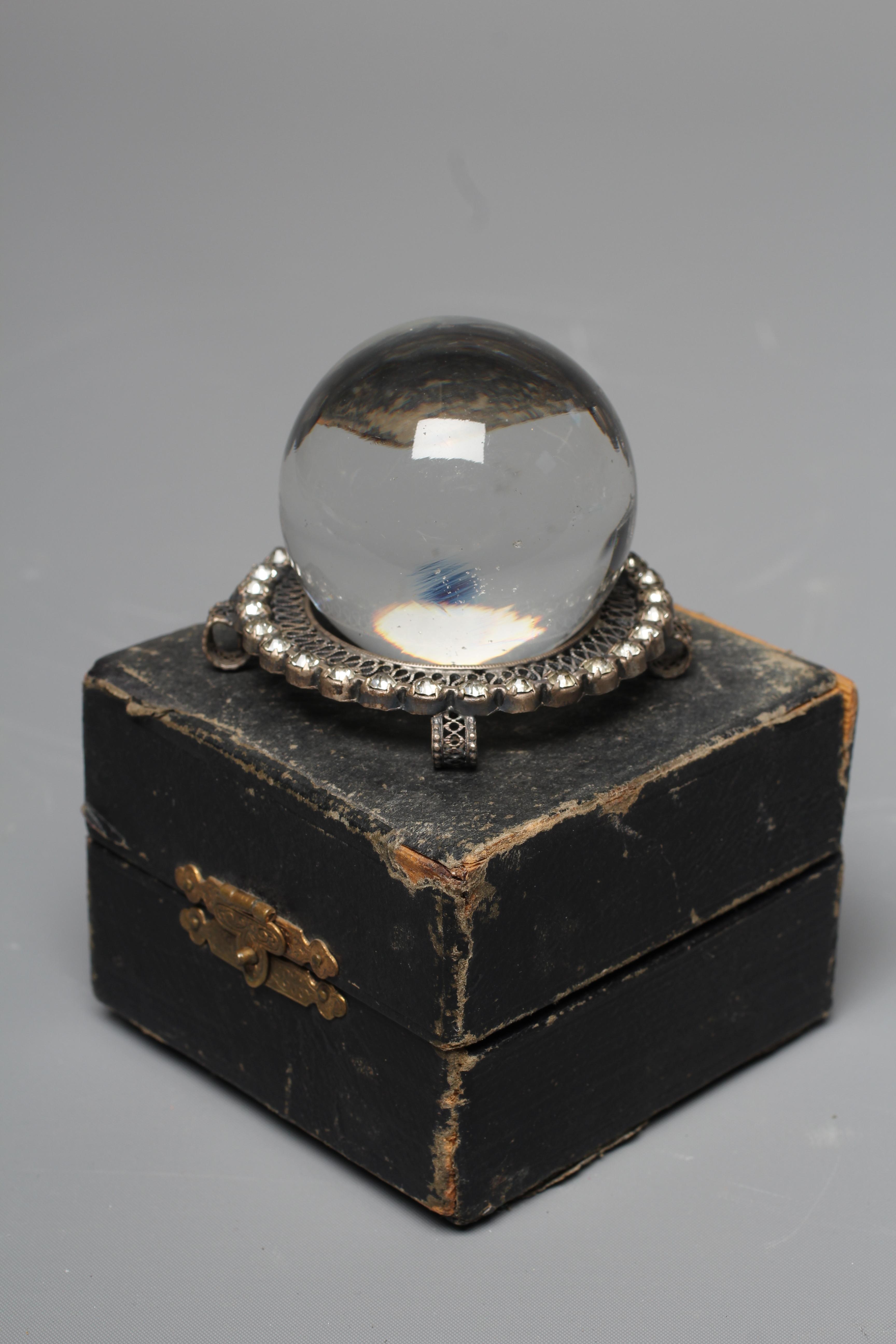 A CRYSTAL BALL, early 20th century, in original silk and velvet lined case, retailed by Two Worlds Image