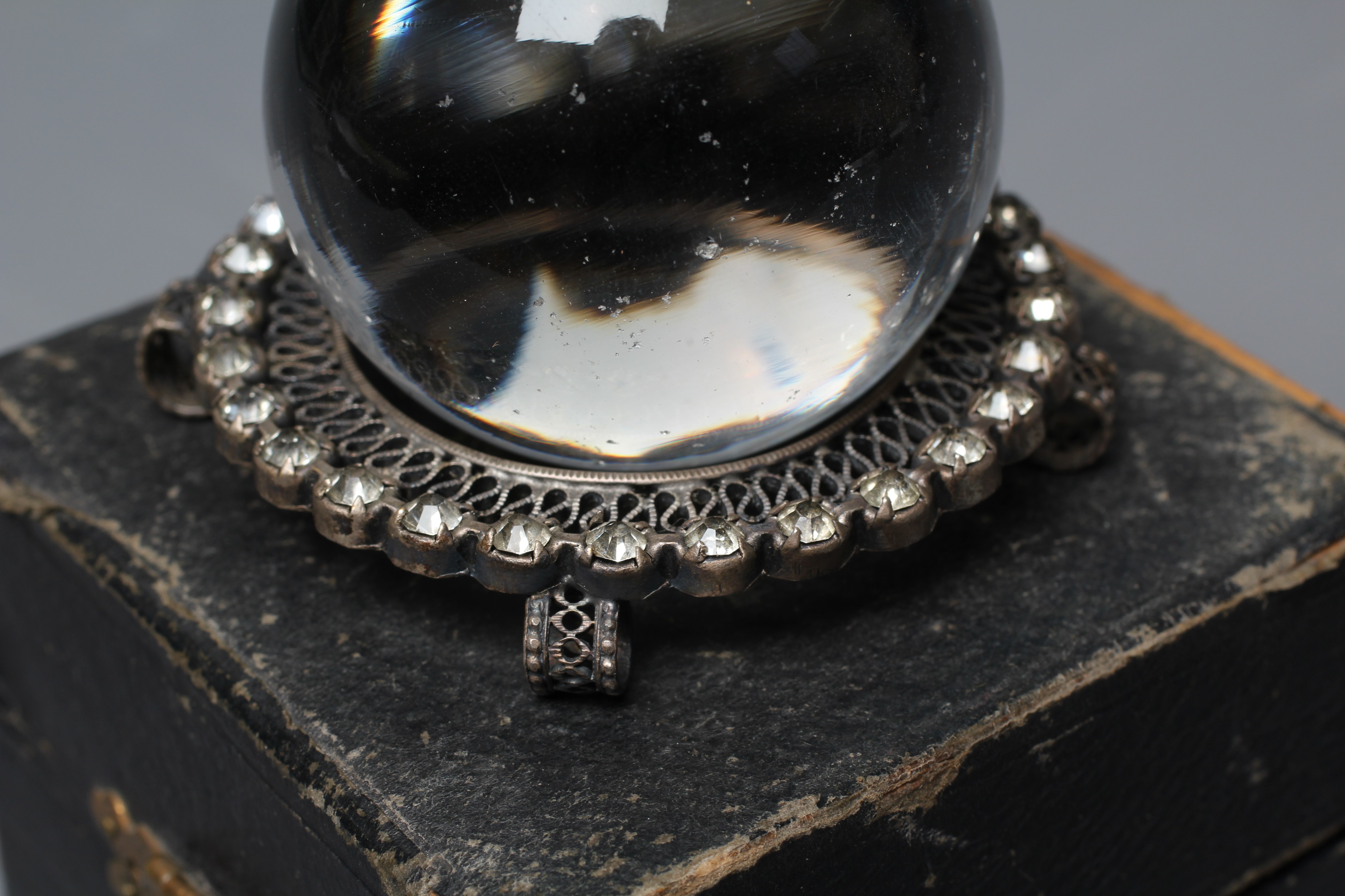 A CRYSTAL BALL, early 20th century, in original silk and velvet lined case, retailed by Two Worlds Image