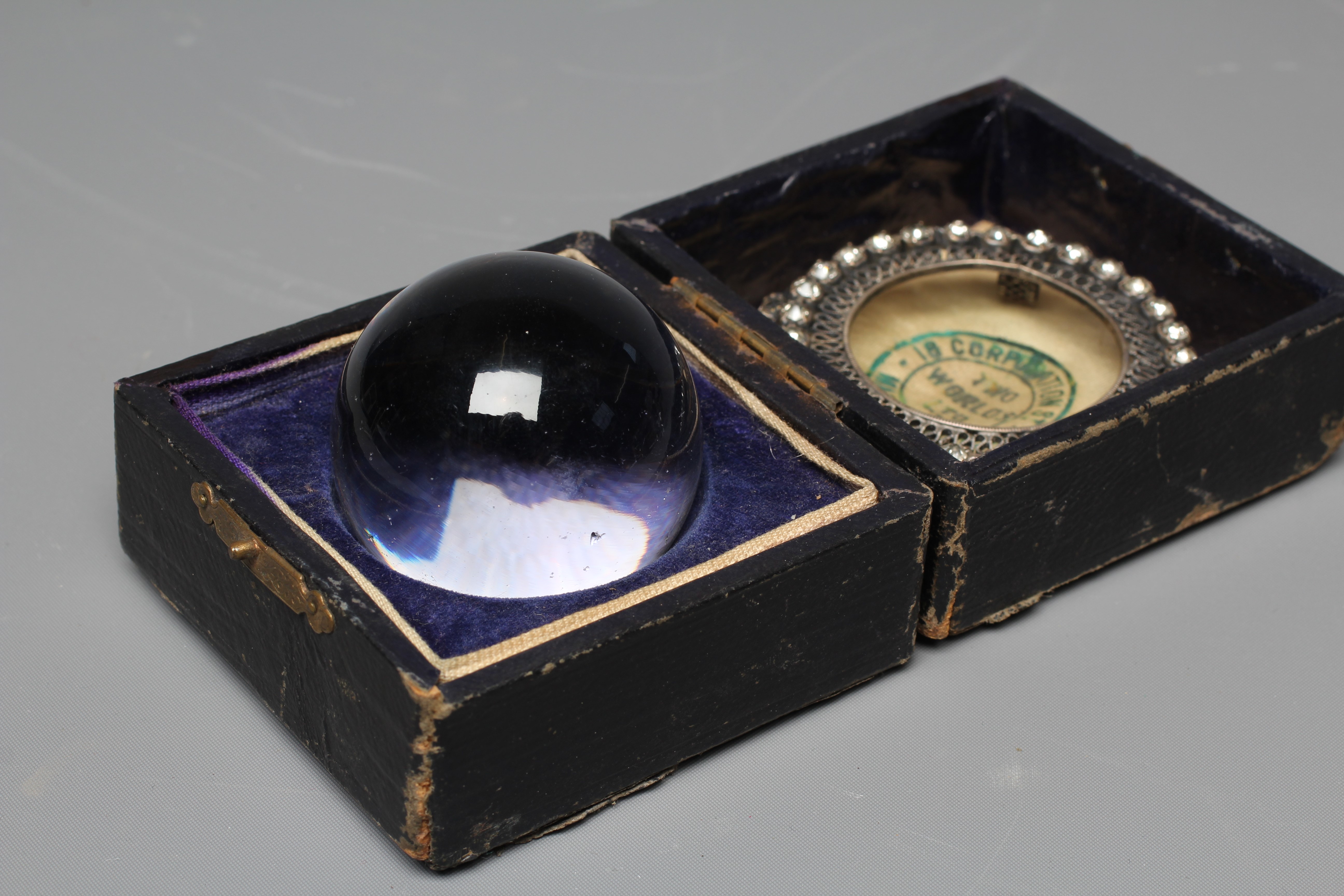 A CRYSTAL BALL, early 20th century, in original silk and velvet lined case, retailed by Two Worlds Image