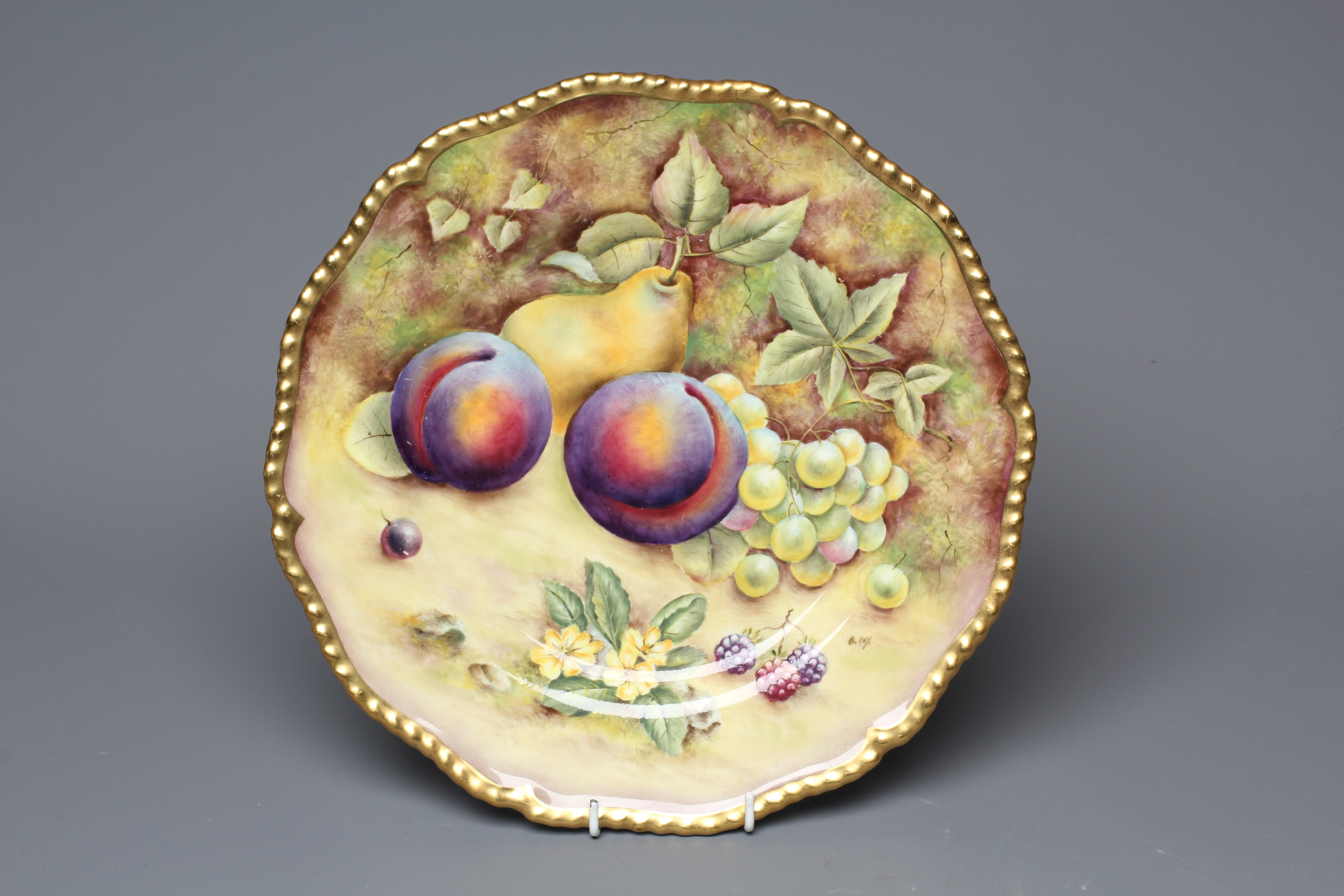 A ROYAL WORCESTER CABINET PLATE, modern, of shaped circular form with gilded gadrooned rim, painted Image