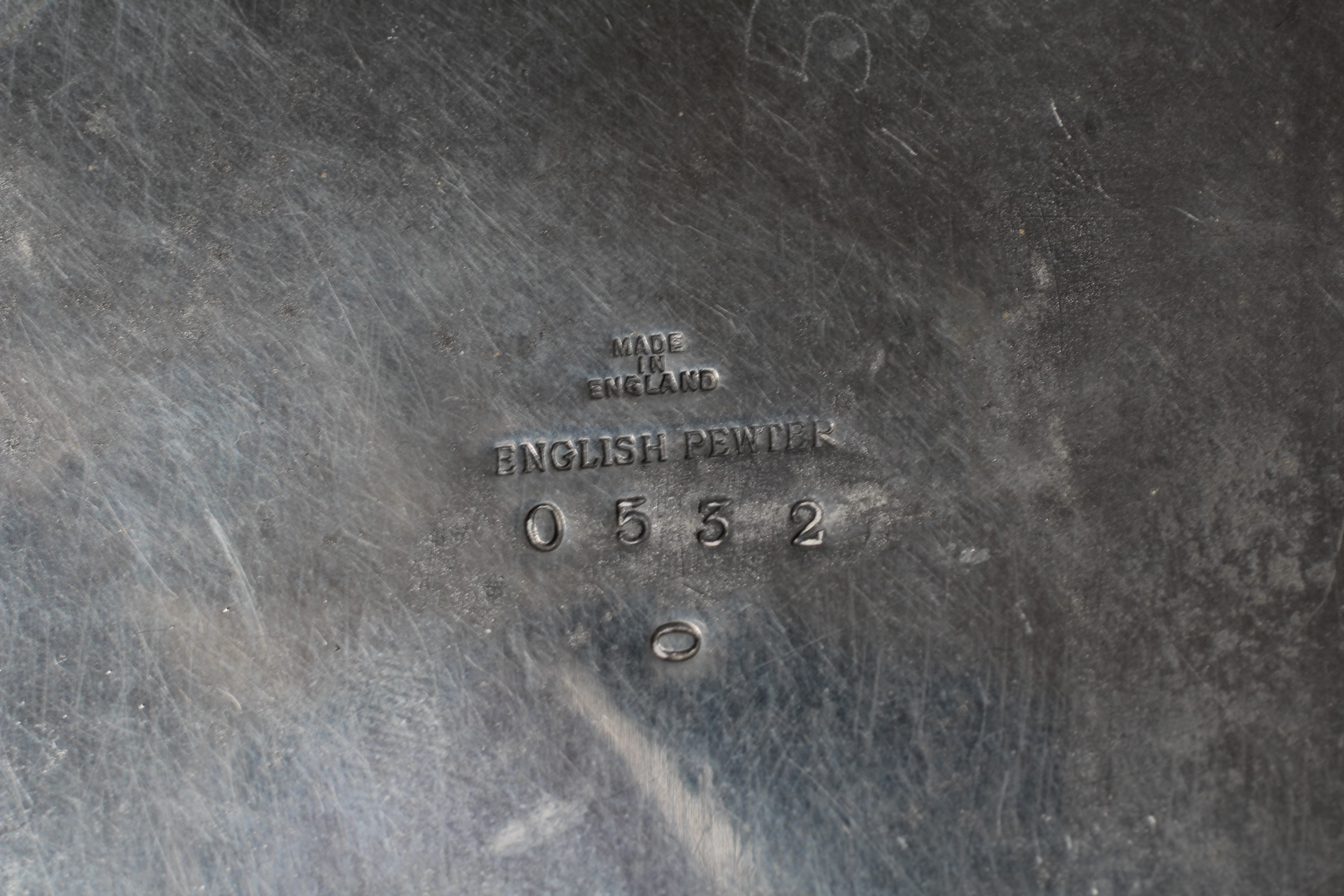 ARCHIBALD KNOX FOR LIBERTY & CO. - An English Pewter demi-lune crumb tray cast with two panels of Image