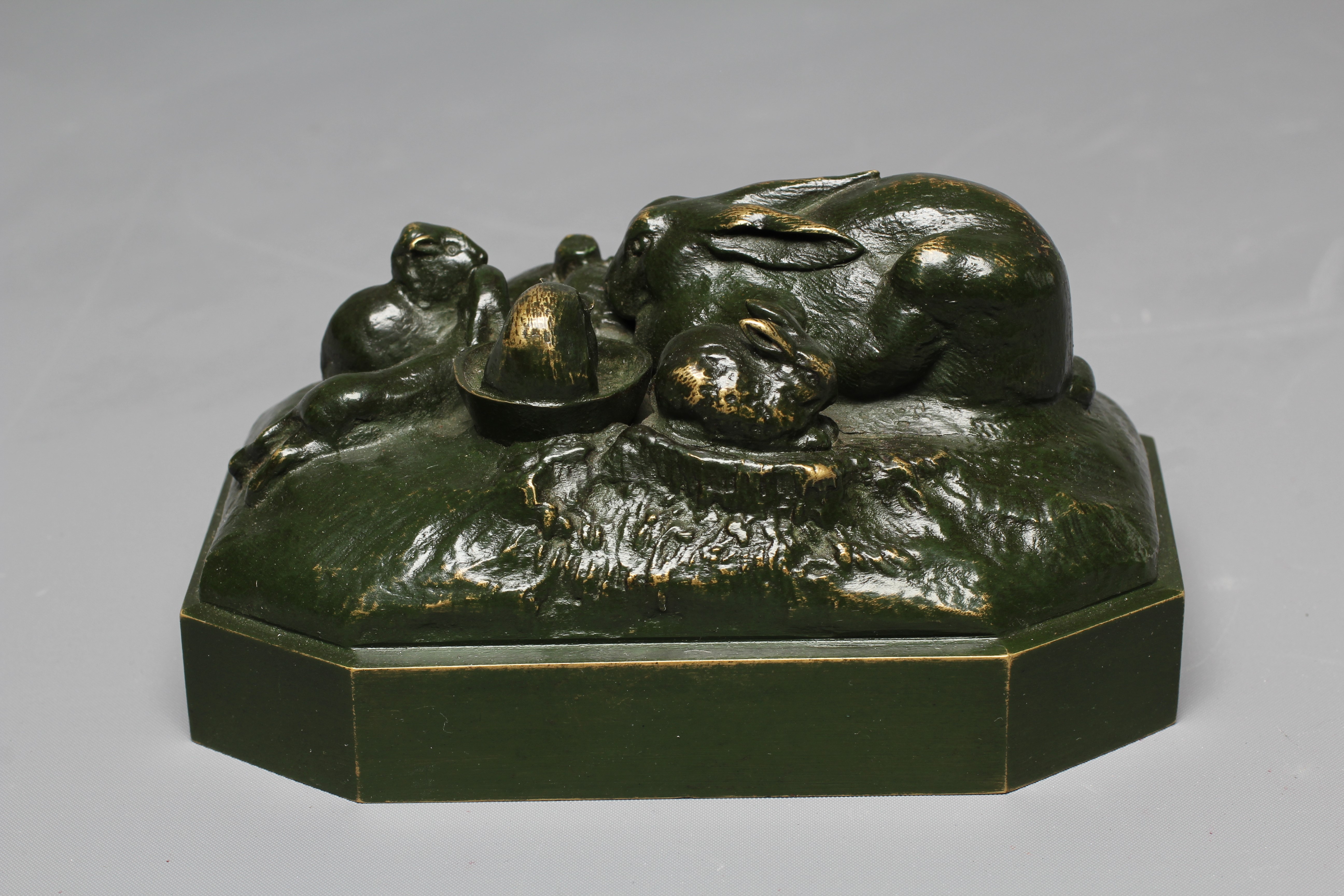 A 20TH CENTURY BRONZE OF A RABBIT FAMILY with dark green patina, 3" high Image